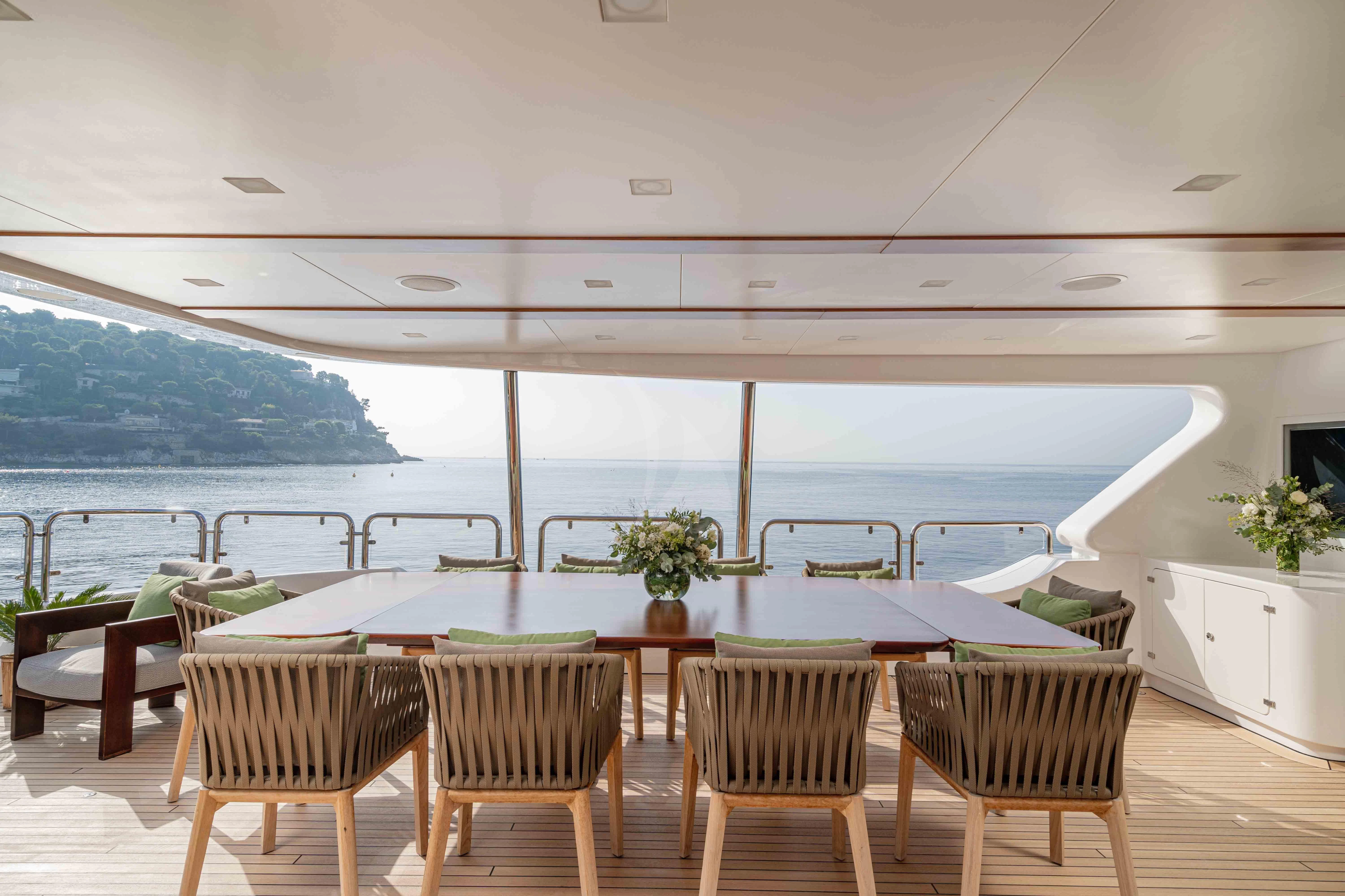 a room with a table and chairs aboard EDESIA Yacht for Sale