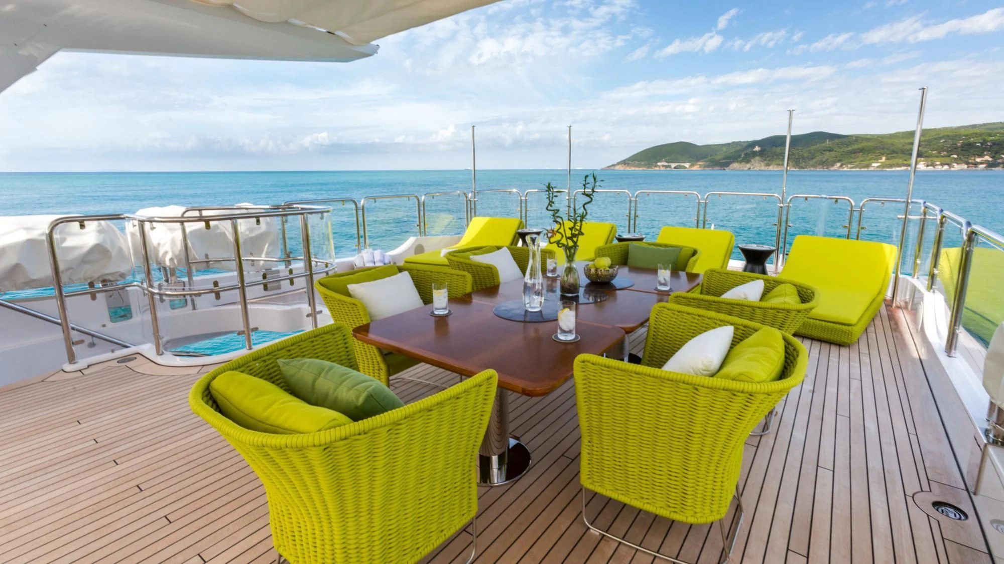 a table with chairs on it next to a body of water aboard EDESIA Yacht for Sale