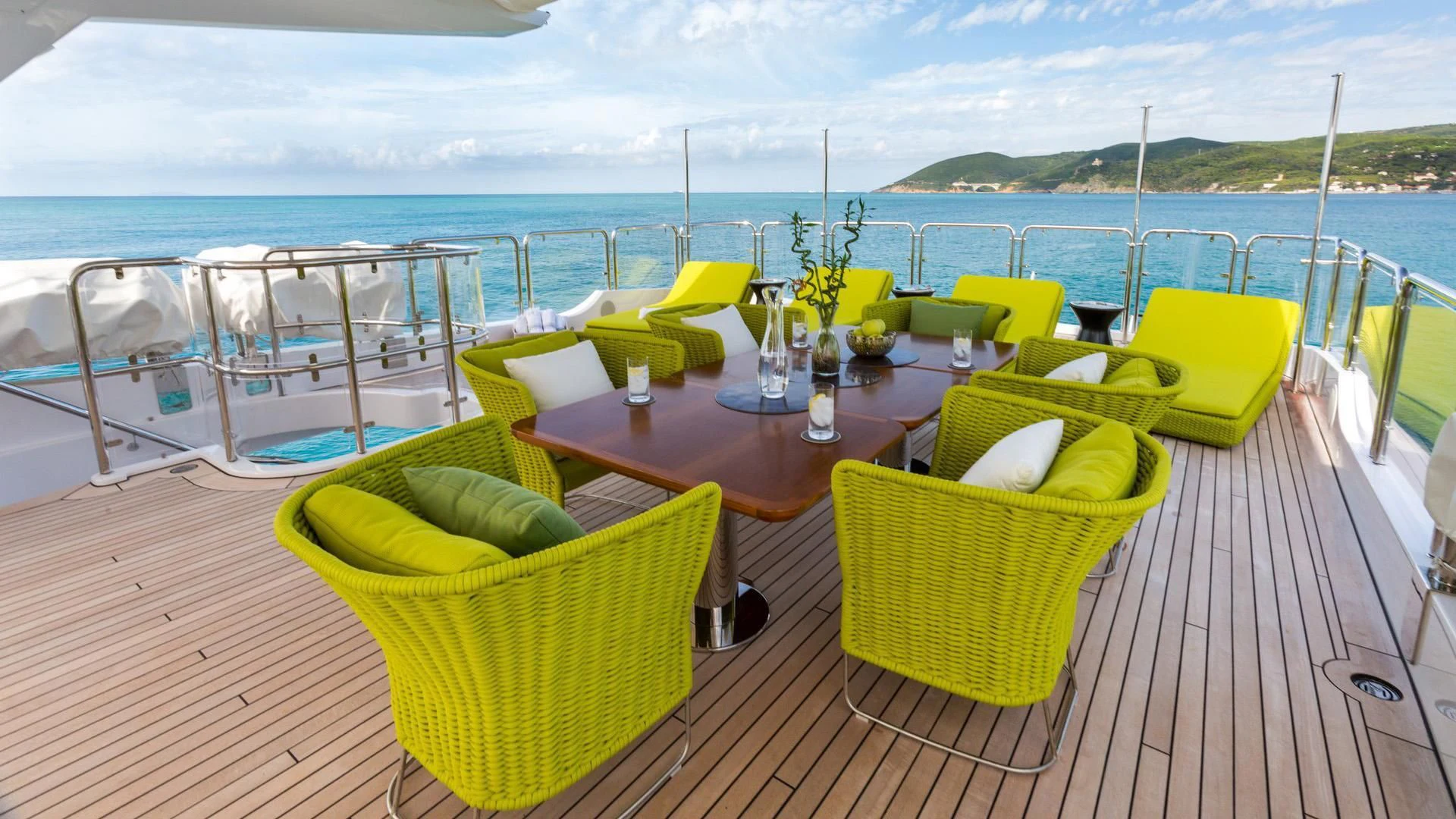 a table with chairs on it next to a body of water aboard EDESIA Yacht for Sale