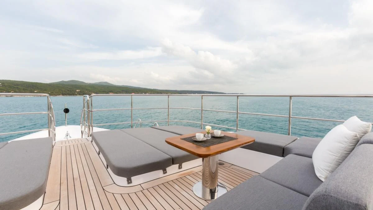 a table on a deck overlooking a body of water aboard EDESIA Yacht for Sale
