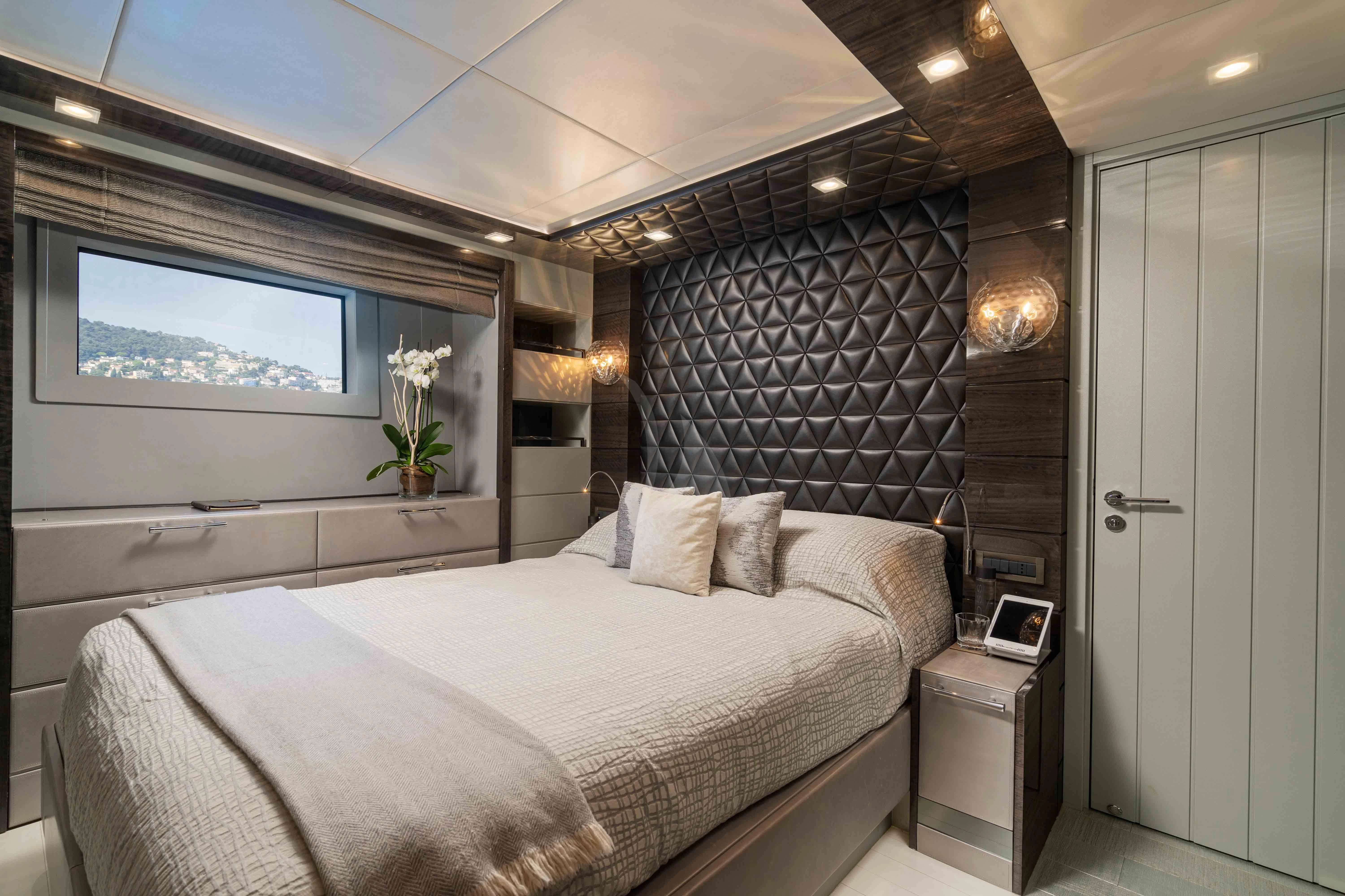 a room with a bed and a television aboard EDESIA Yacht for Sale