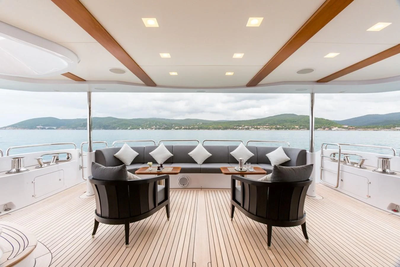a large room with a table and chairs and a large body of water aboard EDESIA Yacht for Sale