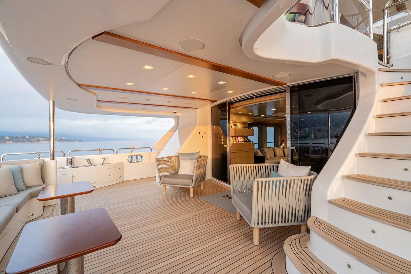 a boat with a deck and chairs aboard EDESIA Yacht for Sale