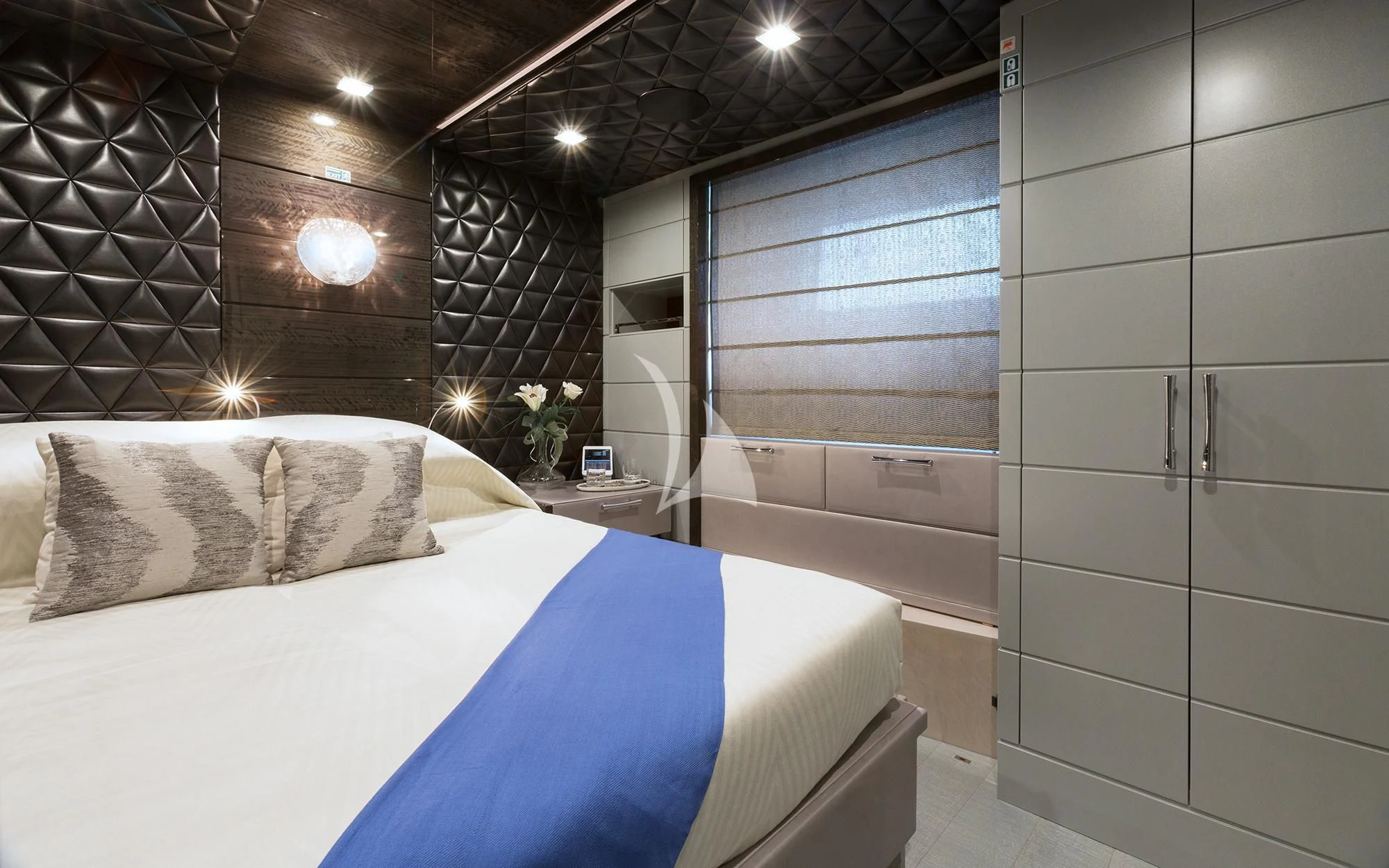 a modern bedroom with a large bed aboard EDESIA Yacht for Sale