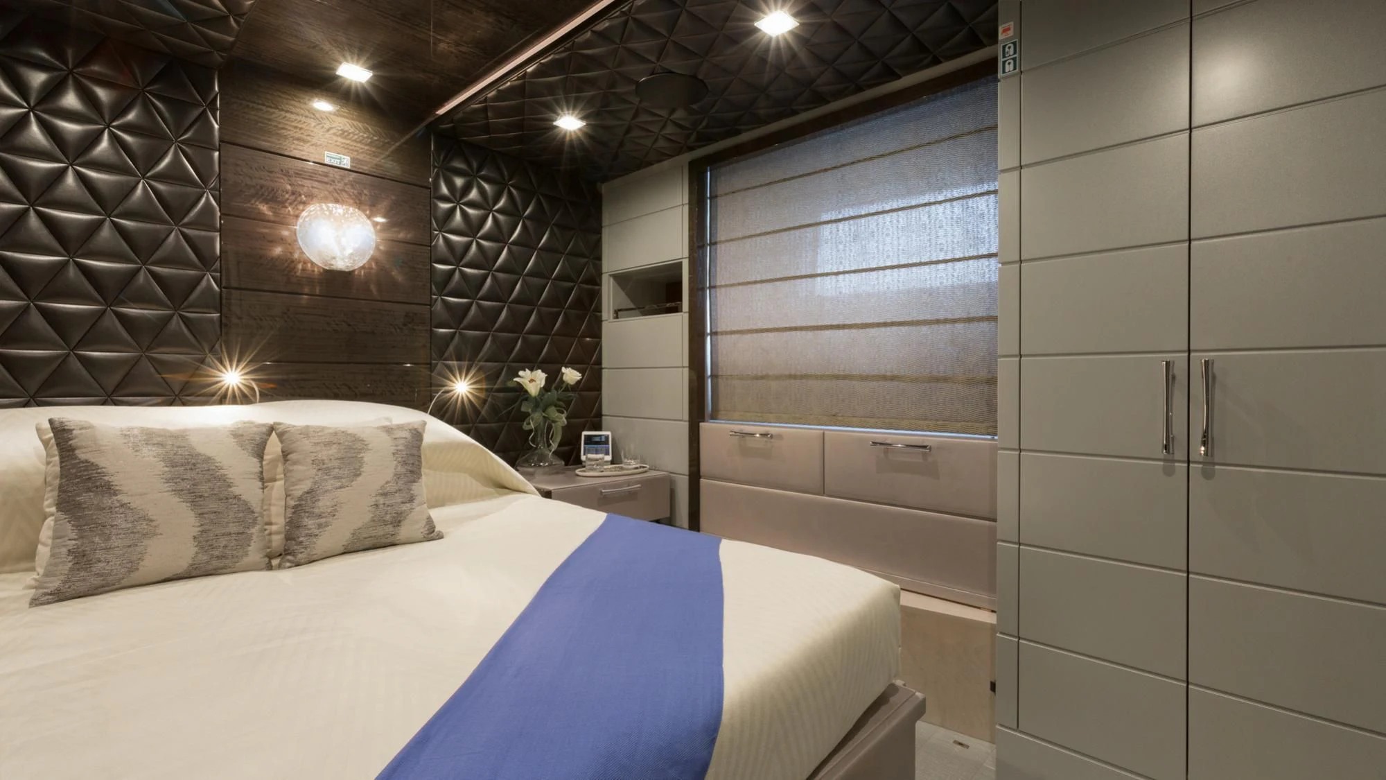 a room with a bed and a window aboard EDESIA Yacht for Sale