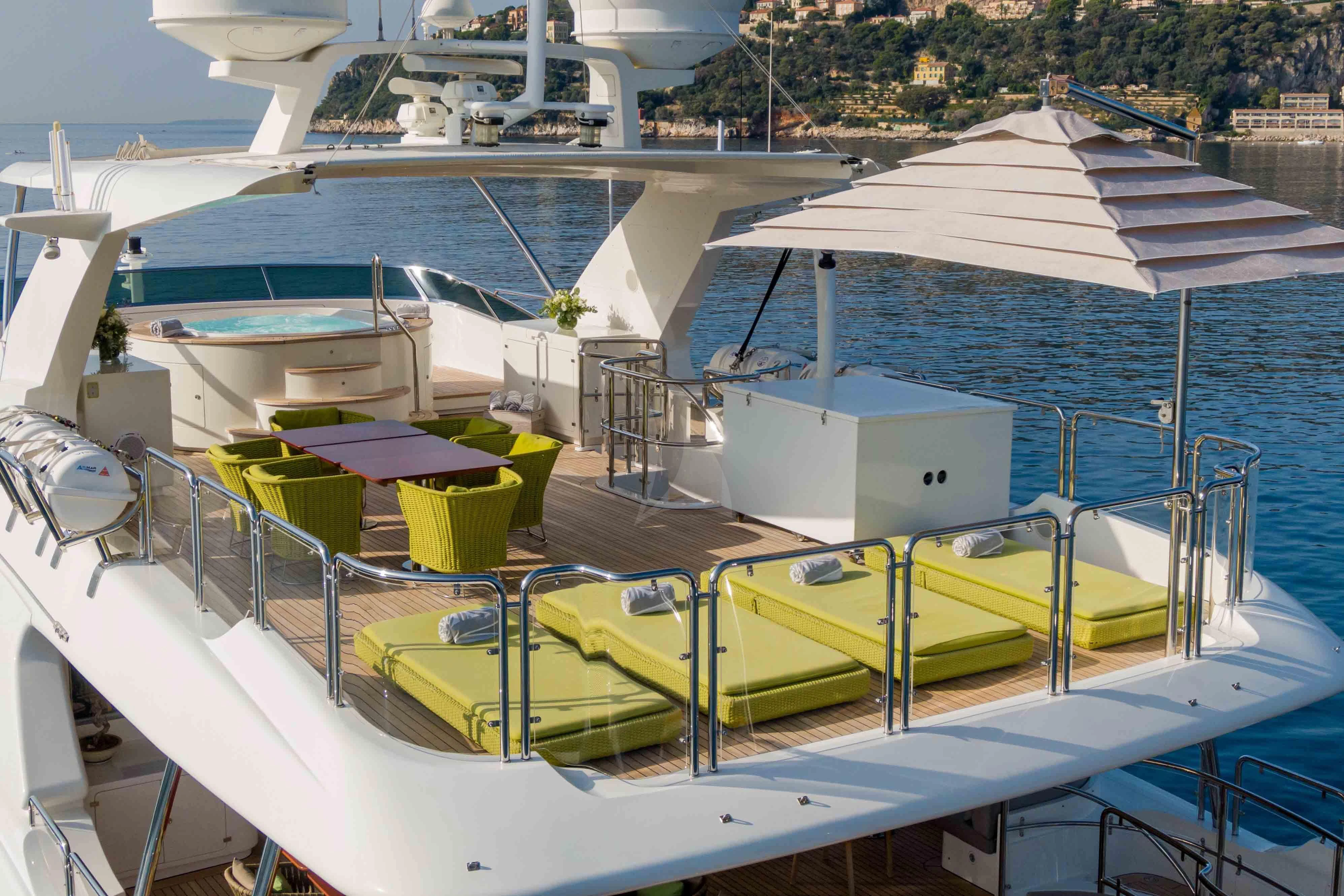a deck with a pool and lounge chairs on it aboard EDESIA Yacht for Sale