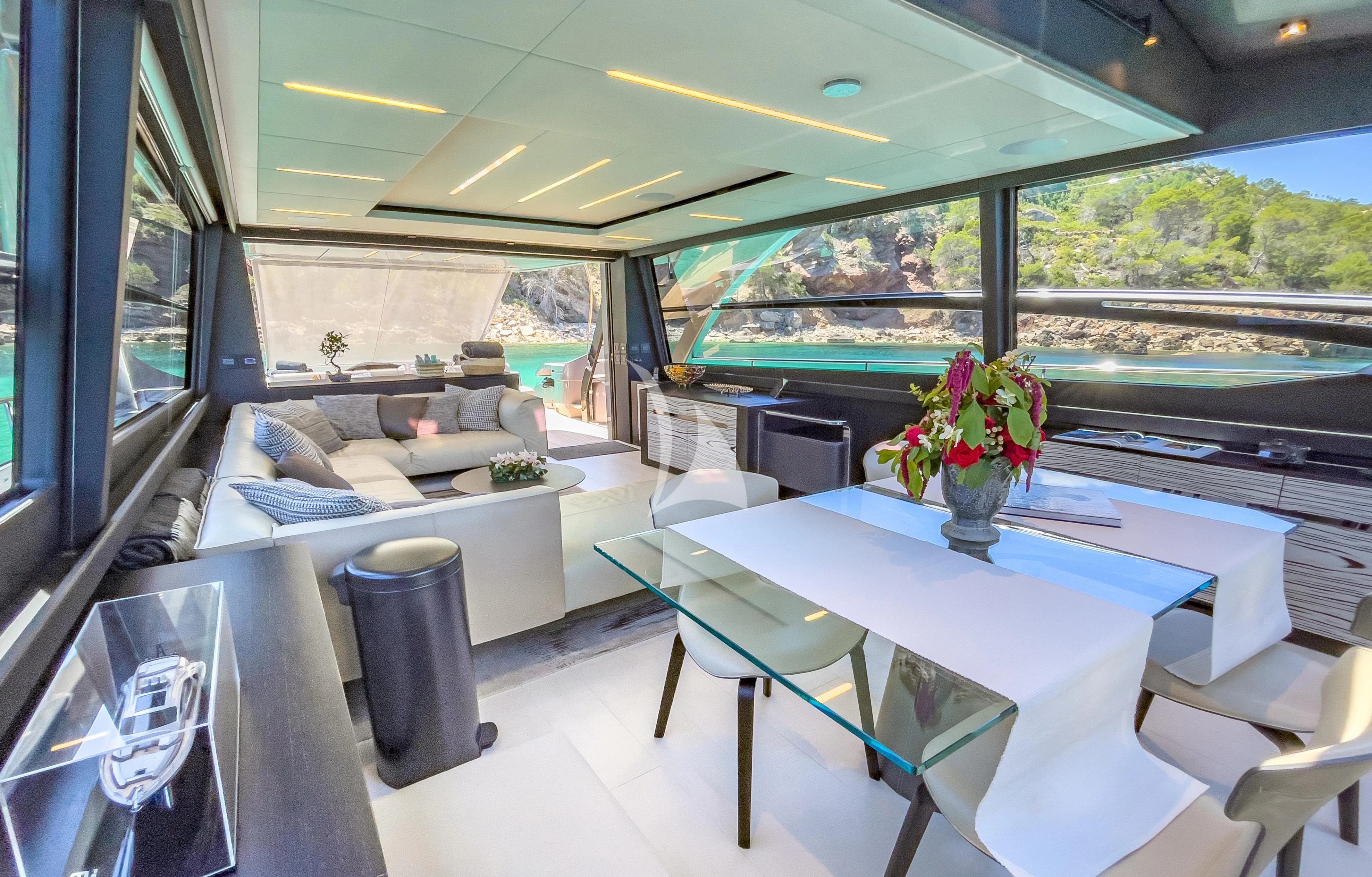 a room with a table and chairs aboard BEYOND Yacht for Sale