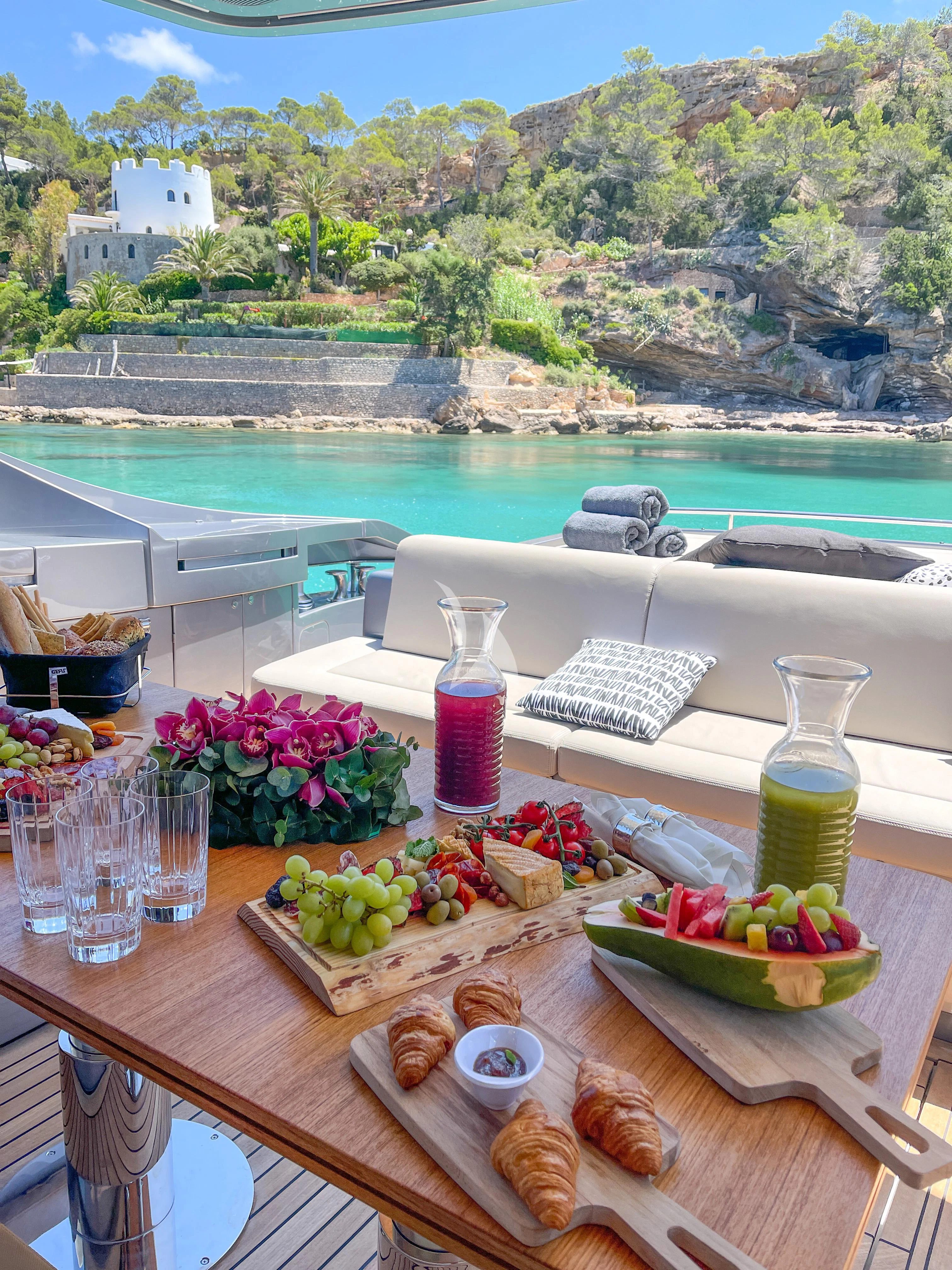 a table with food and drinks on it aboard BEYOND Yacht for Sale