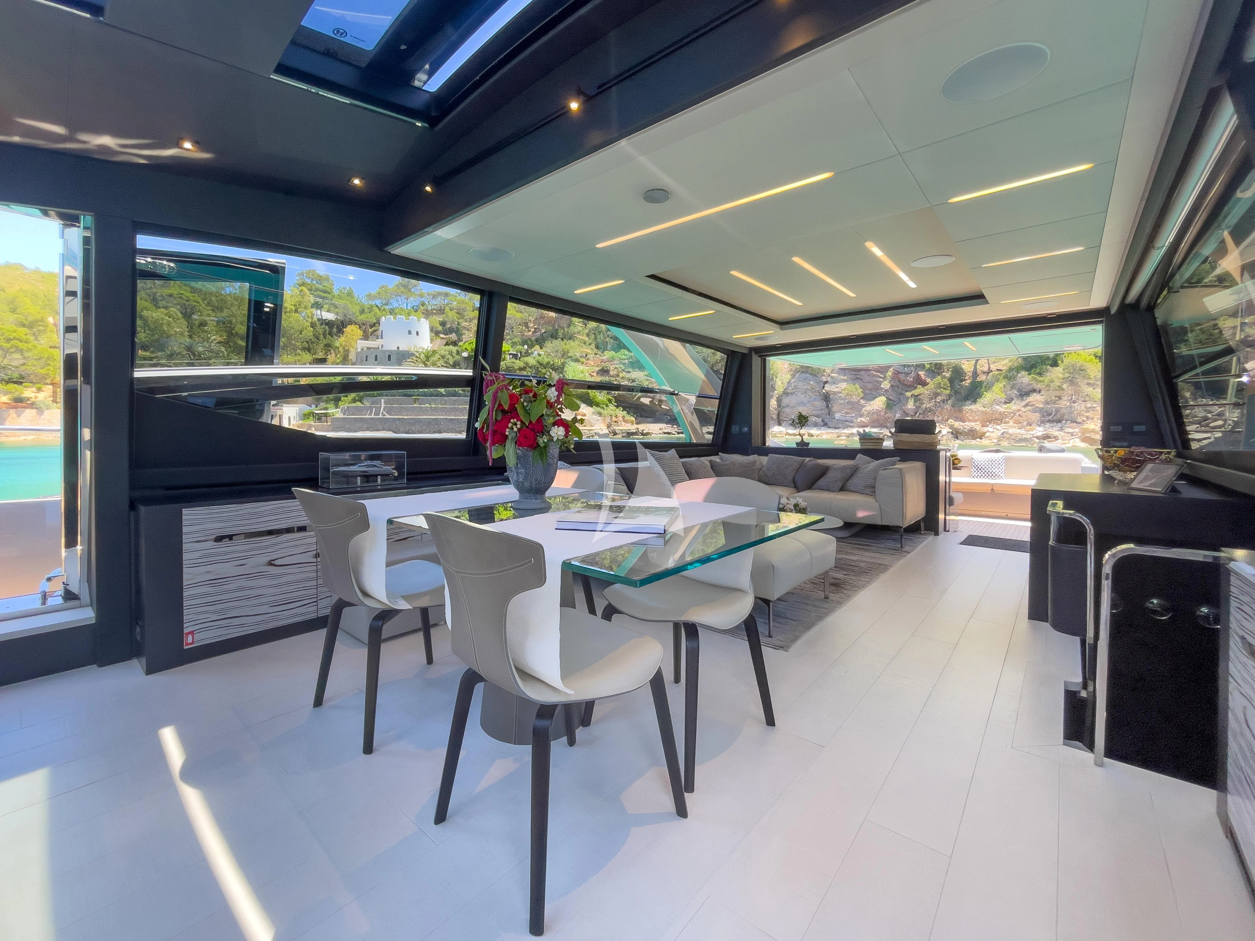a large room with a table and chairs aboard BEYOND Yacht for Sale