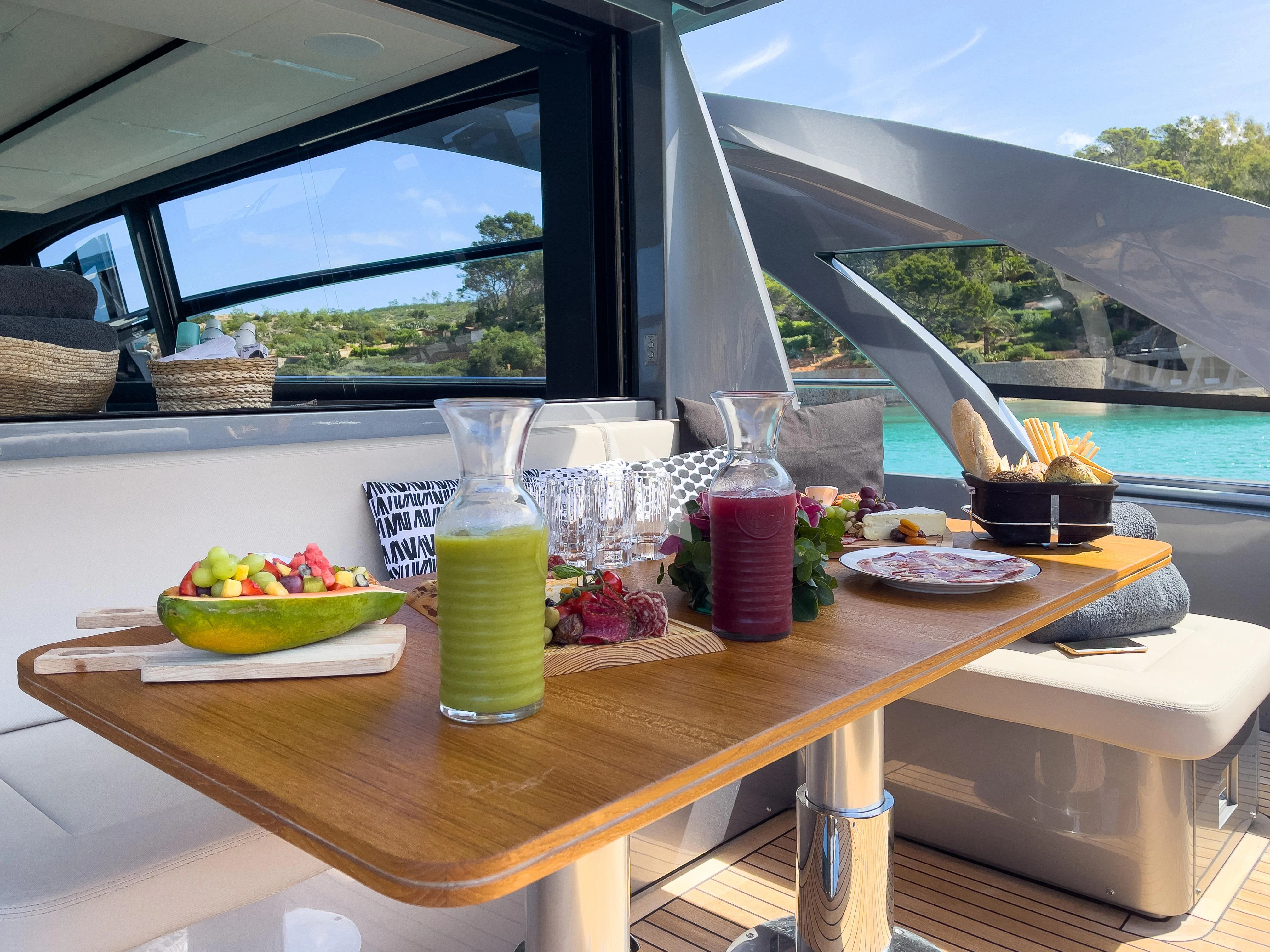 a table with food and drinks aboard BEYOND Yacht for Sale