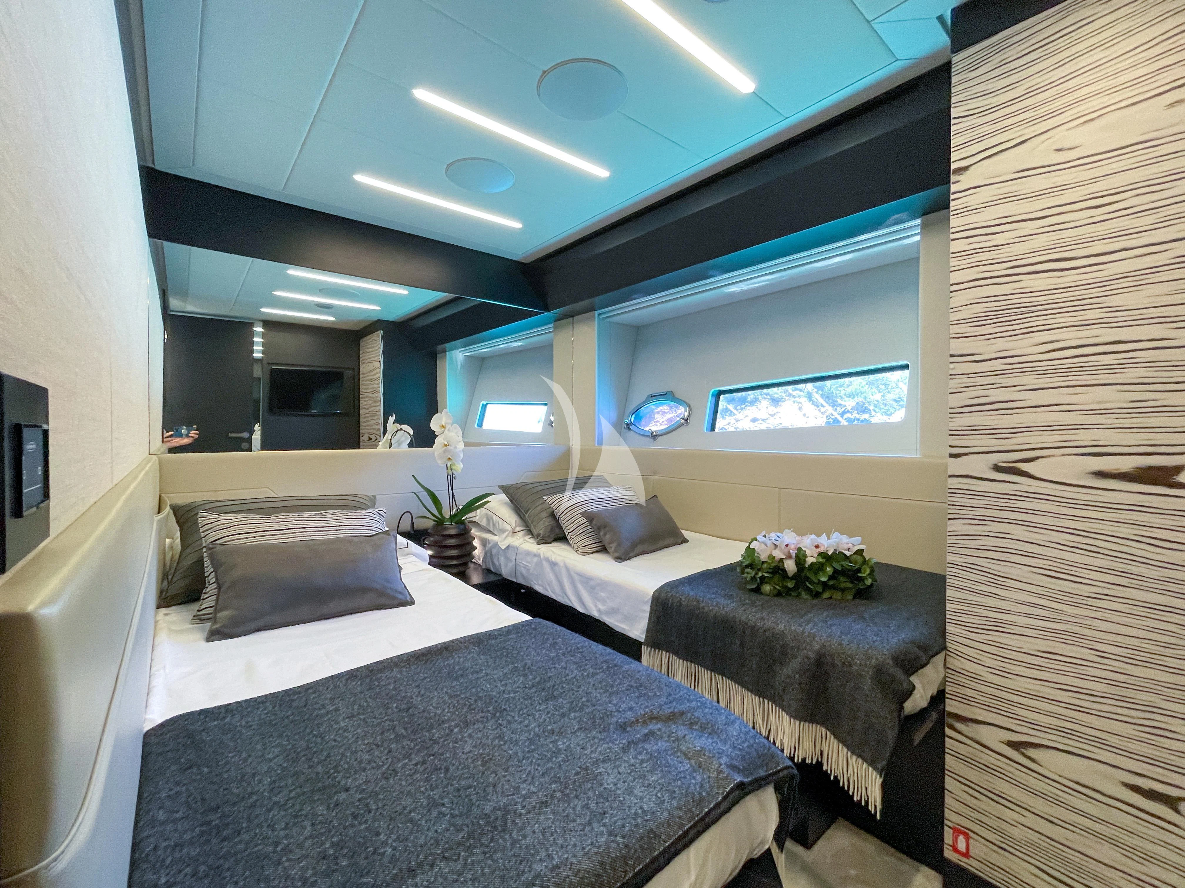 a room with two beds aboard BEYOND Yacht for Sale