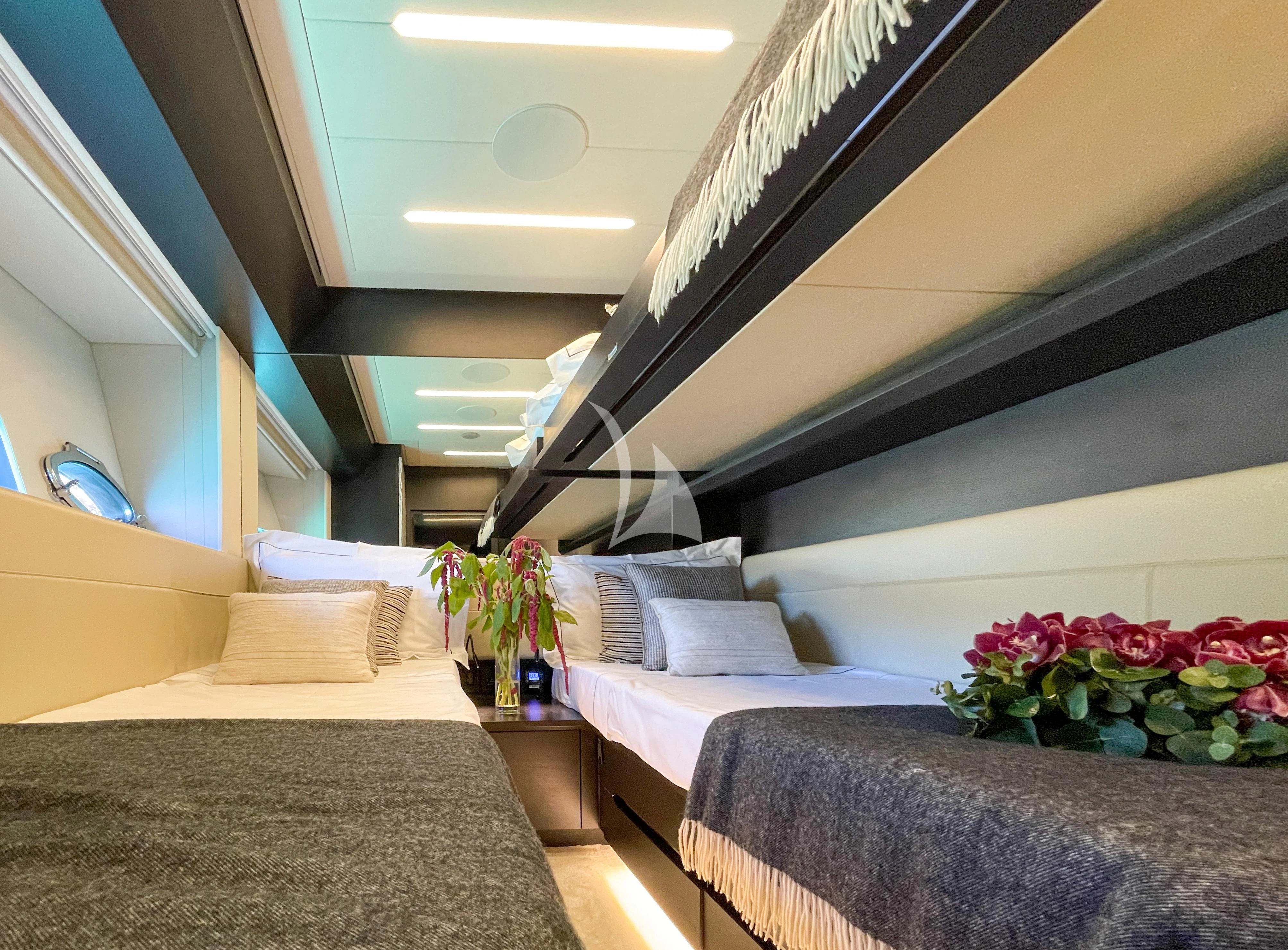 a room with a bed and a couch aboard BEYOND Yacht for Sale