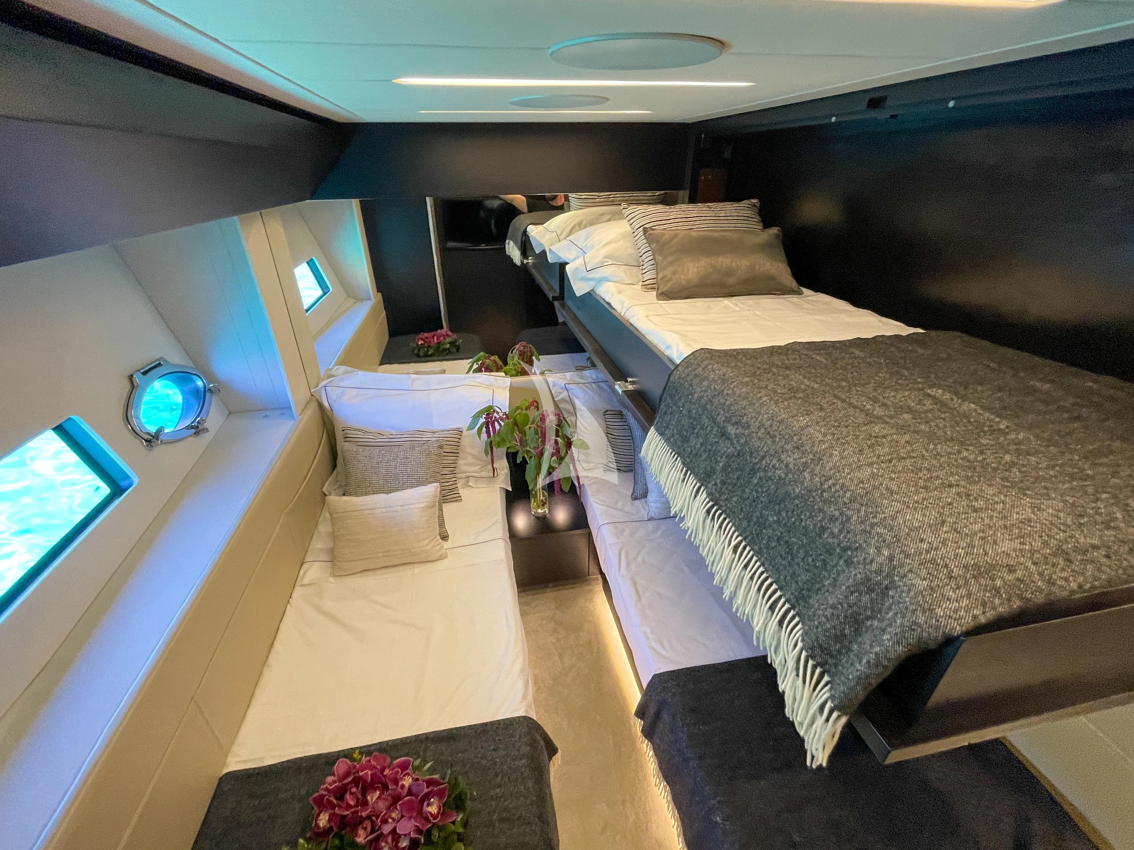 a room with a bed and a couch aboard BEYOND Yacht for Sale