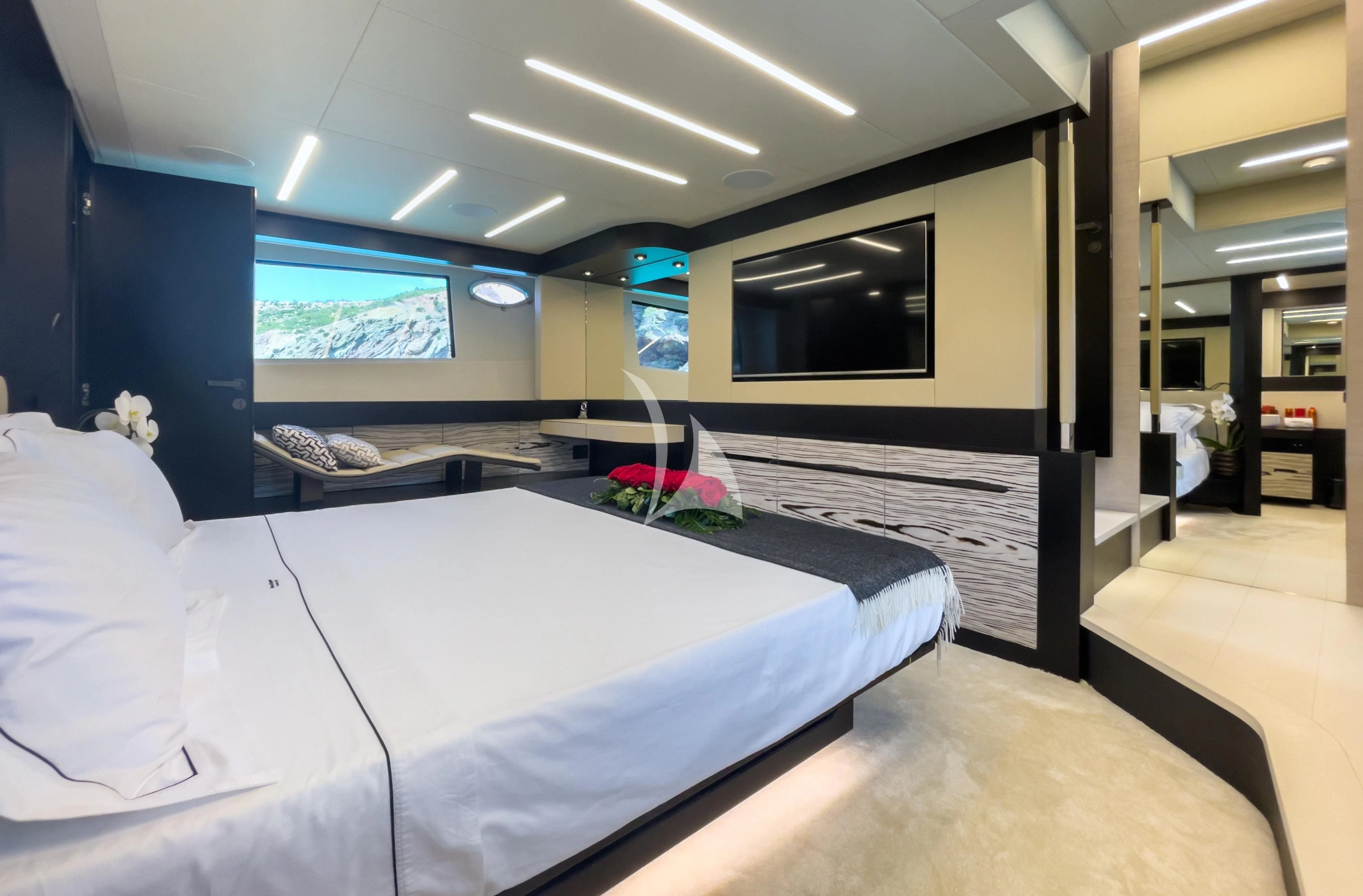 a room with beds and a tv aboard BEYOND Yacht for Sale