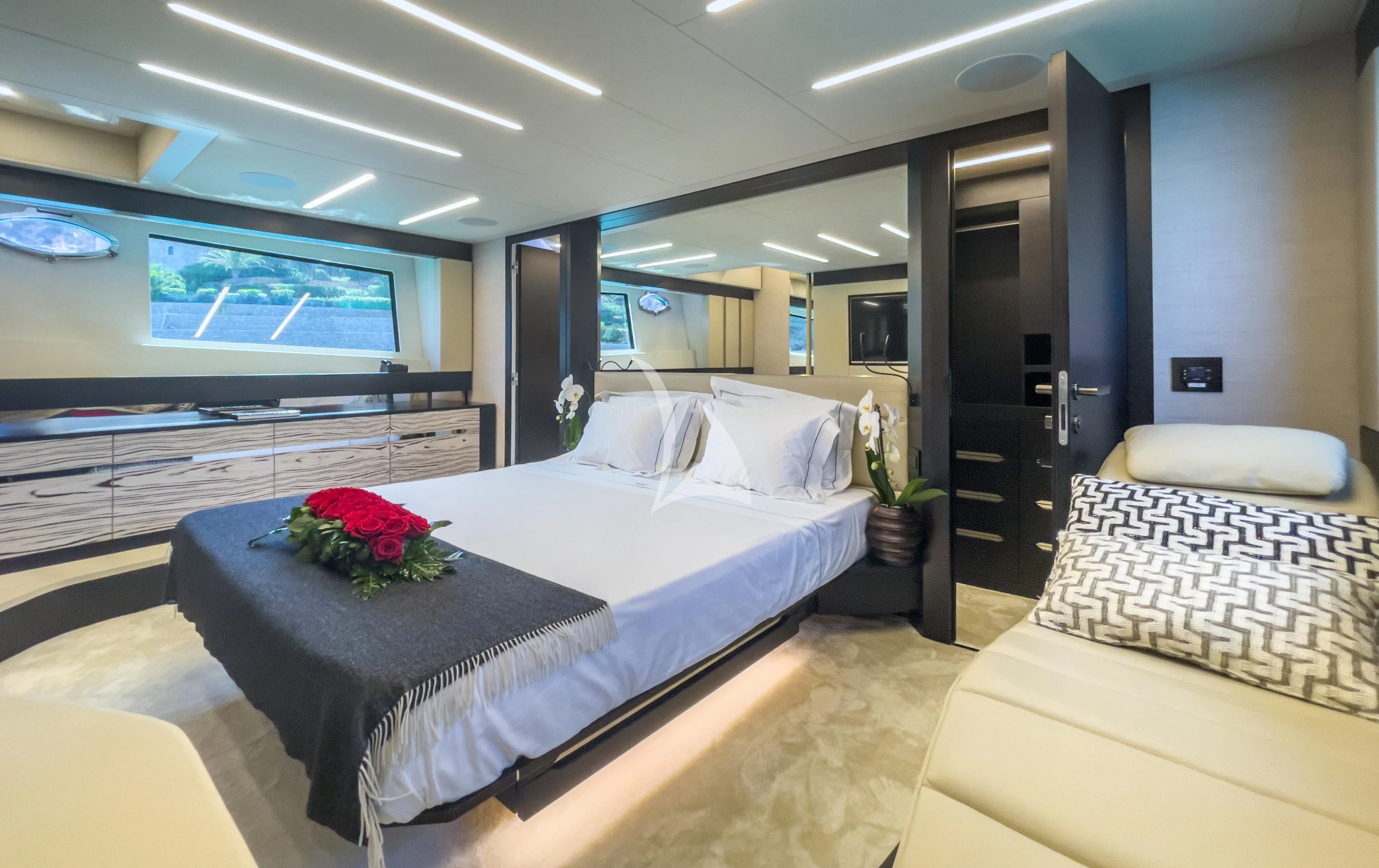 a room with a bed and a tv on the wall aboard BEYOND Yacht for Sale