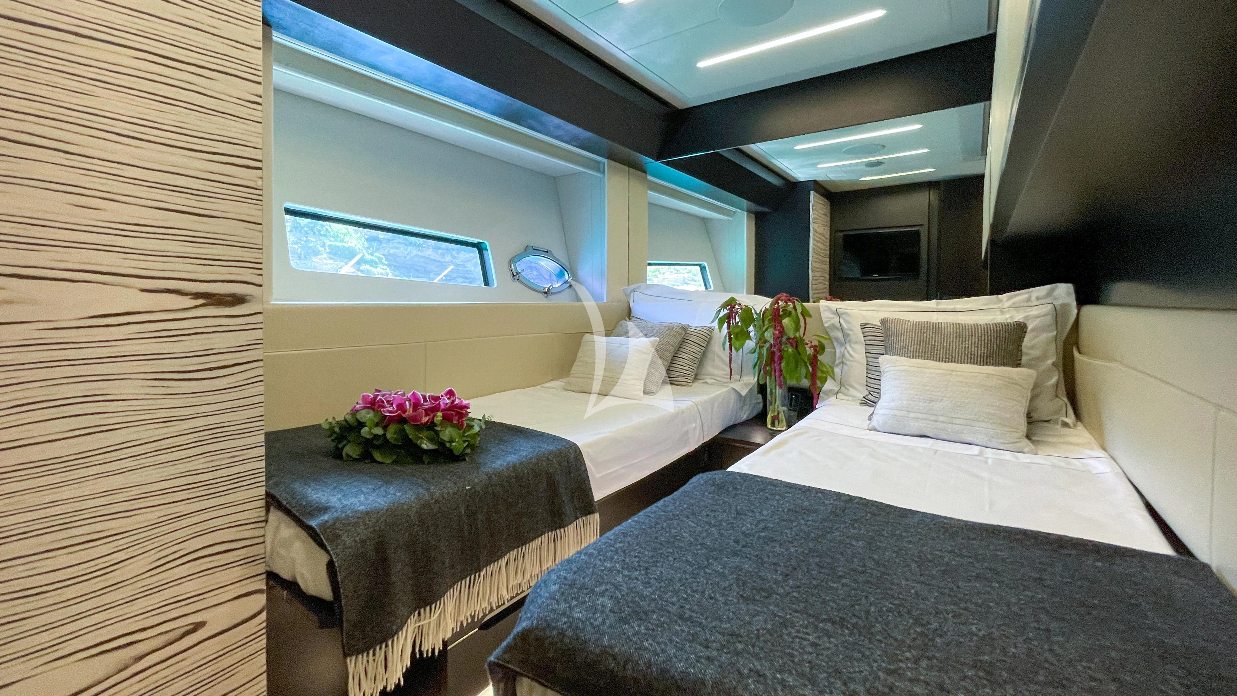 a room with two beds aboard BEYOND Yacht for Sale