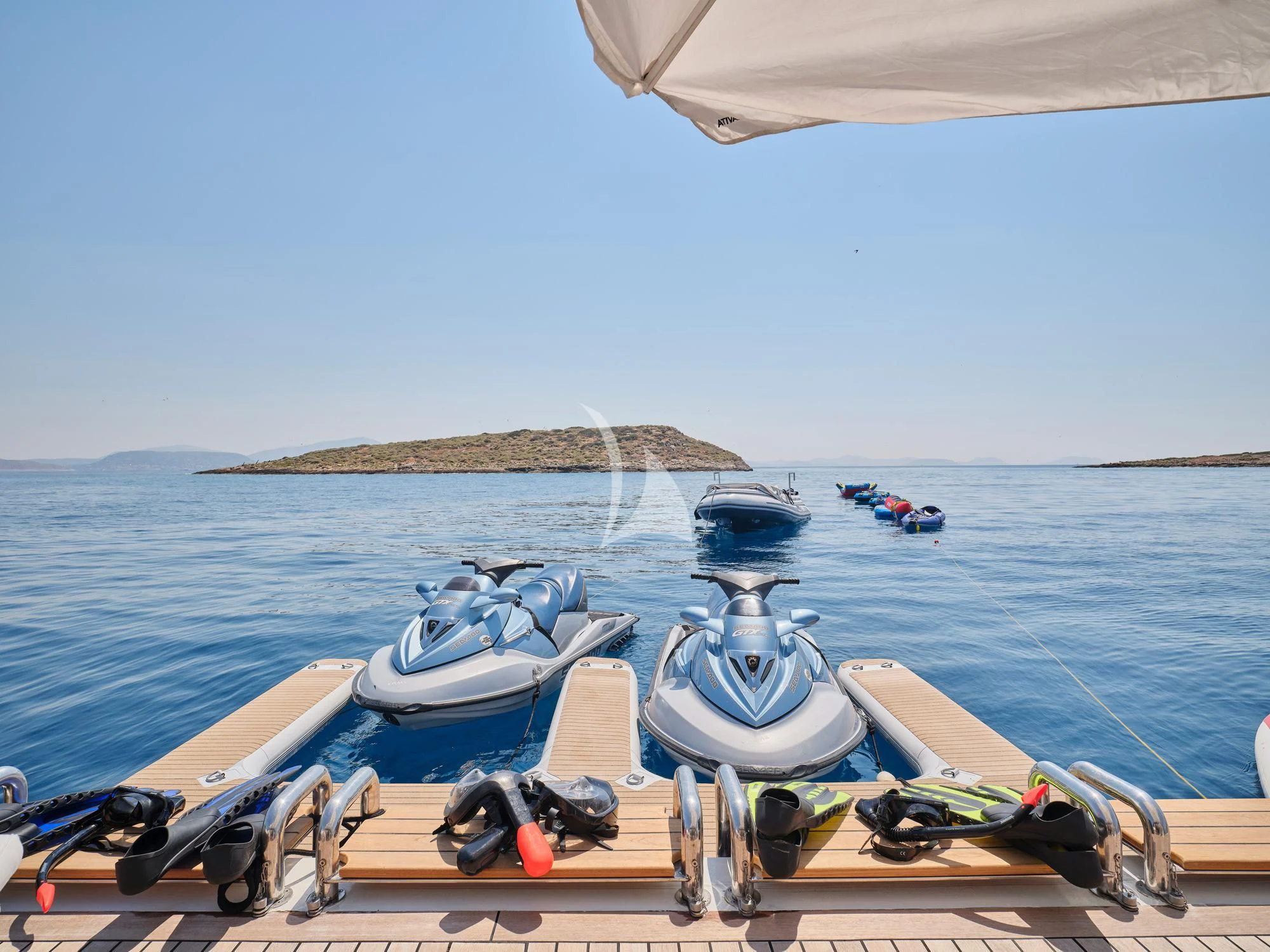 a boat with several motor boats aboard SUNDAY Yacht for Charter