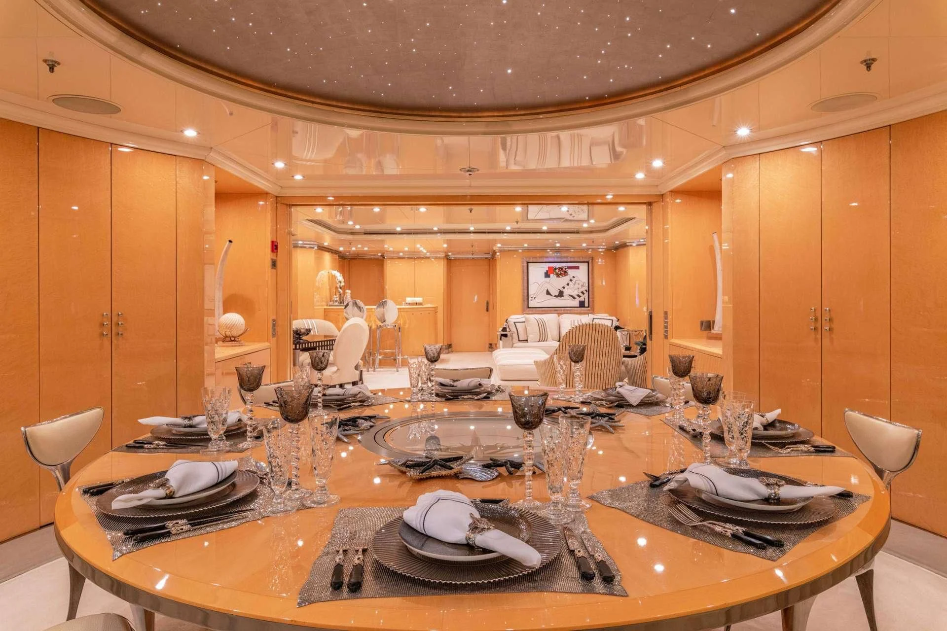 a large dining room with a table set for dinner aboard SUNDAY Yacht for Charter