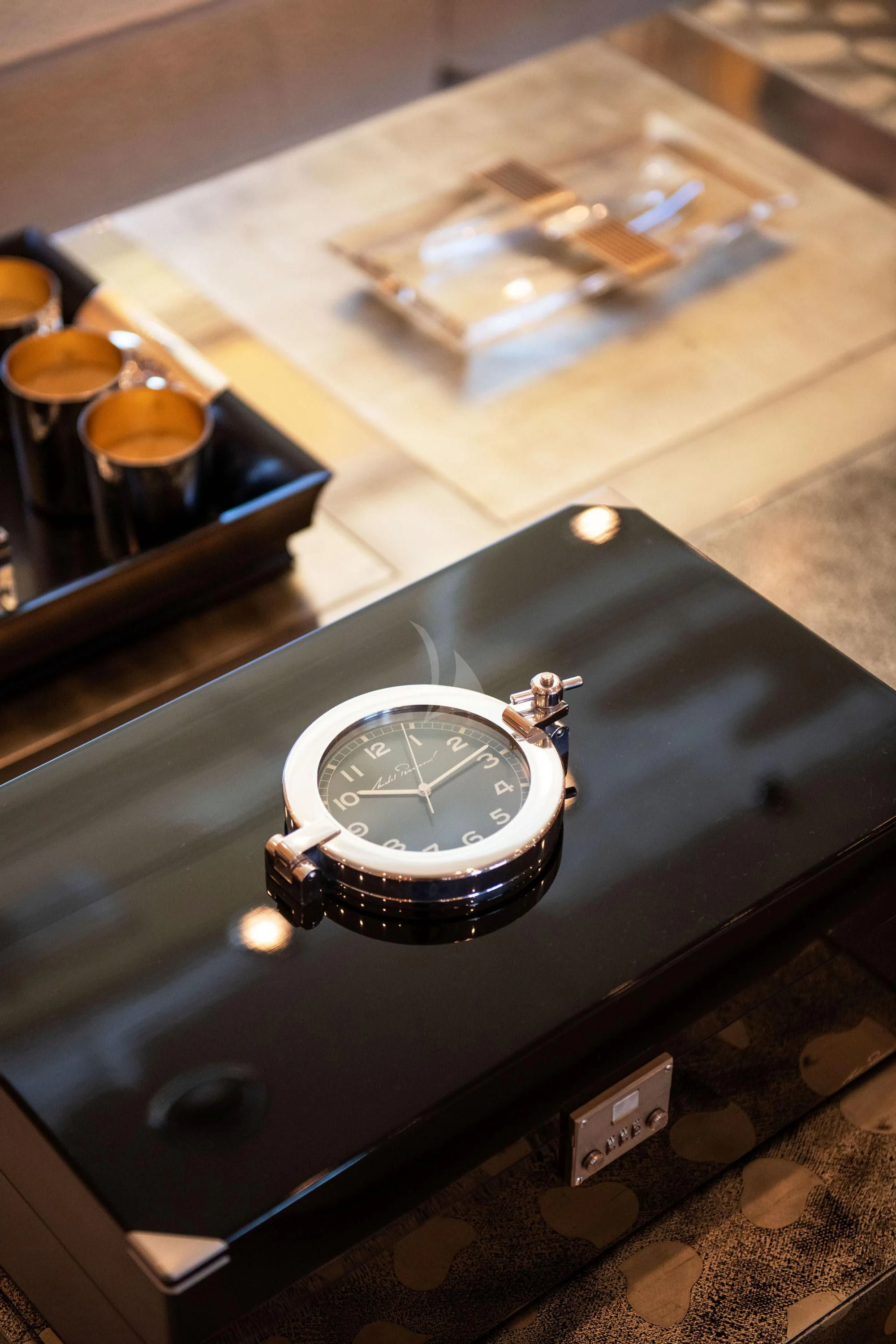 a watch on a table aboard SUNDAY Yacht for Charter