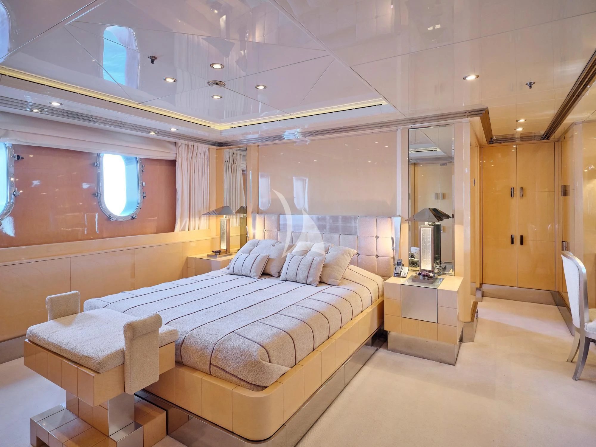 a room with a bed and a mirror aboard SUNDAY Yacht for Charter