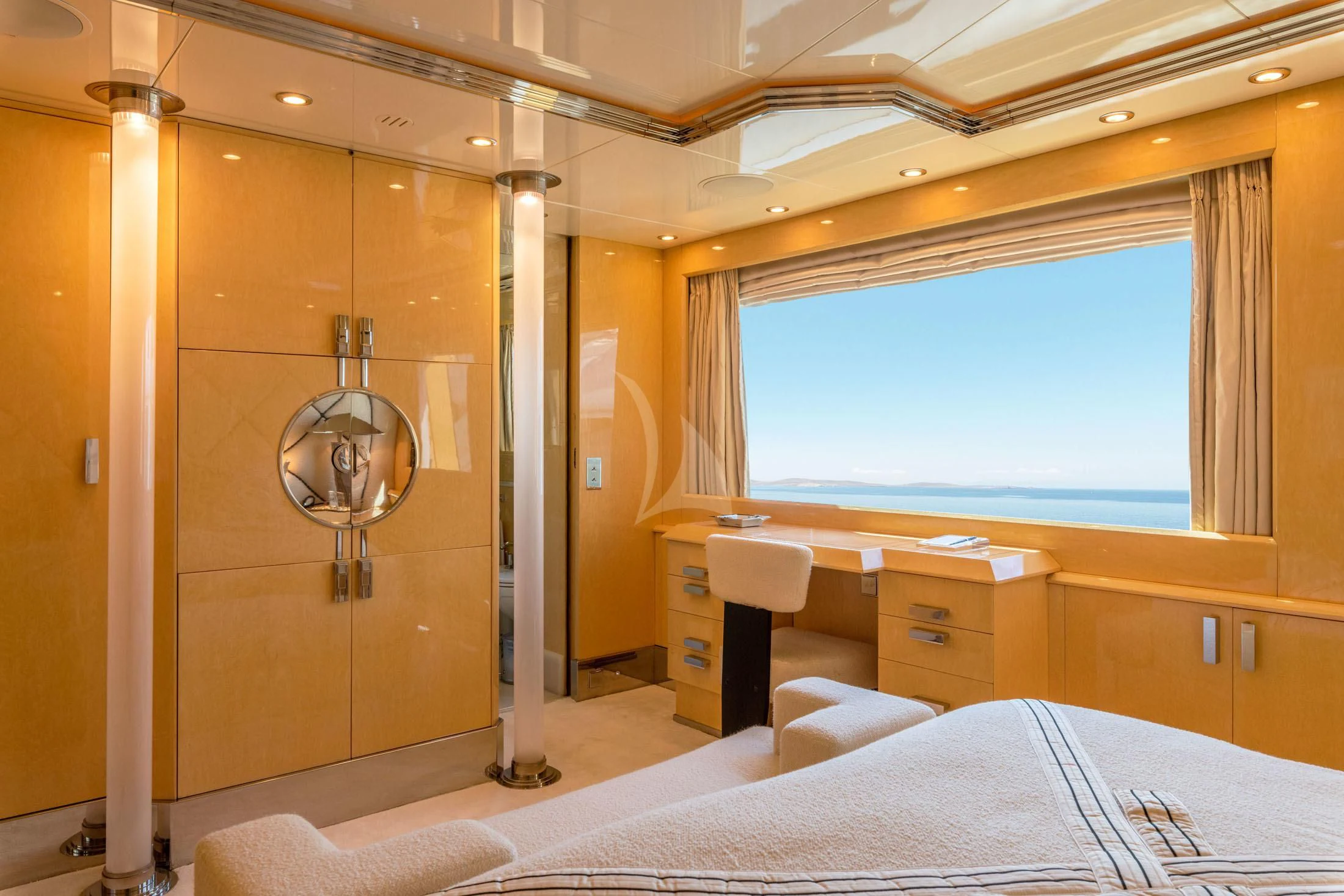 a bedroom with a bed and a desk aboard SUNDAY Yacht for Charter