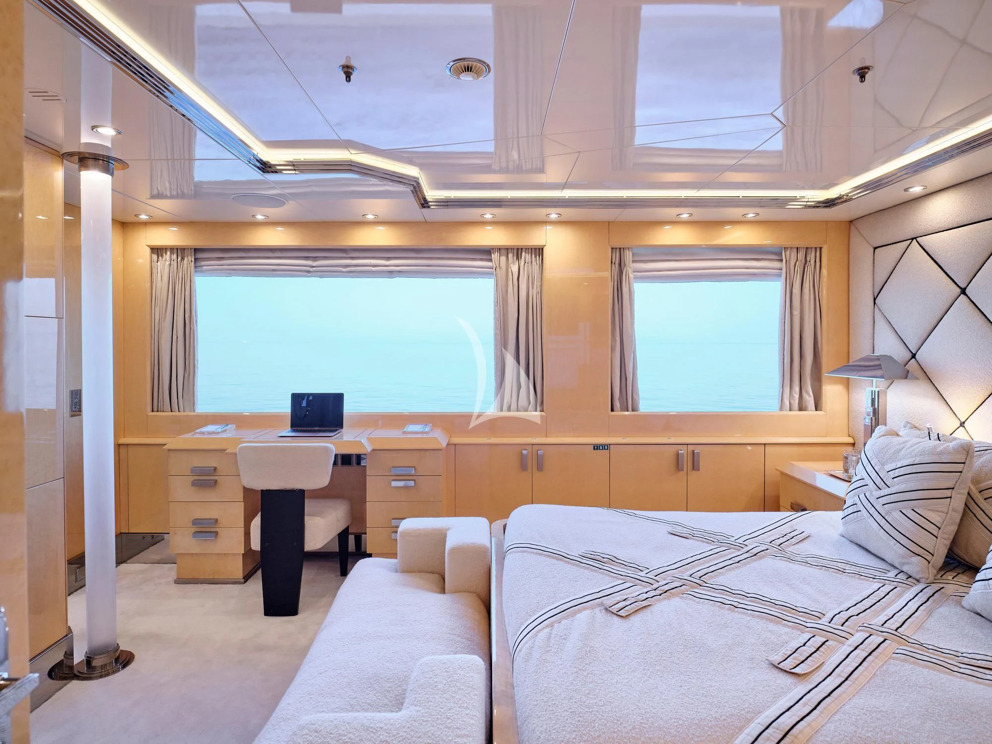 a room with a bed and a desk aboard SUNDAY Yacht for Charter