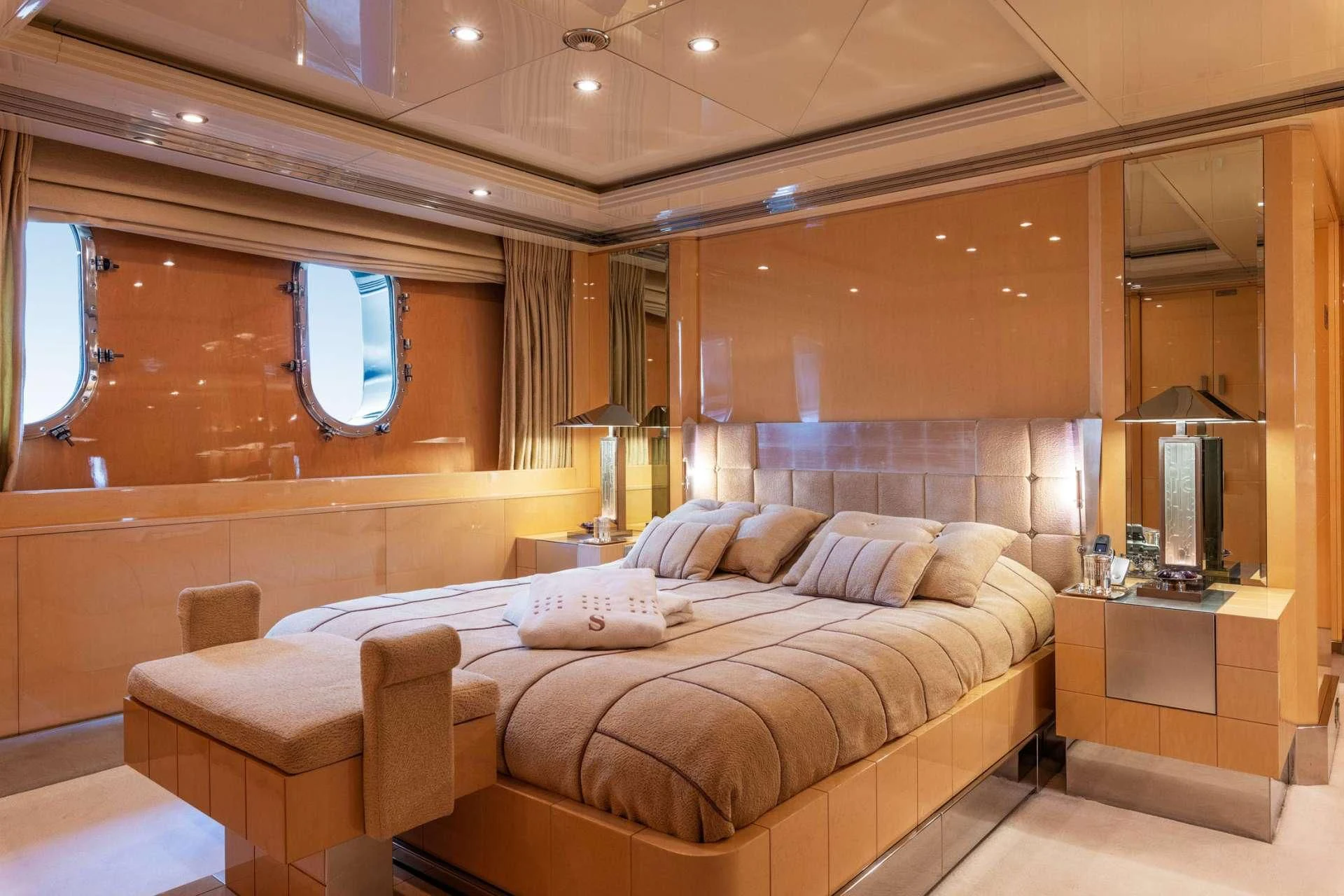 a room with a bed and a mirror aboard SUNDAY Yacht for Charter