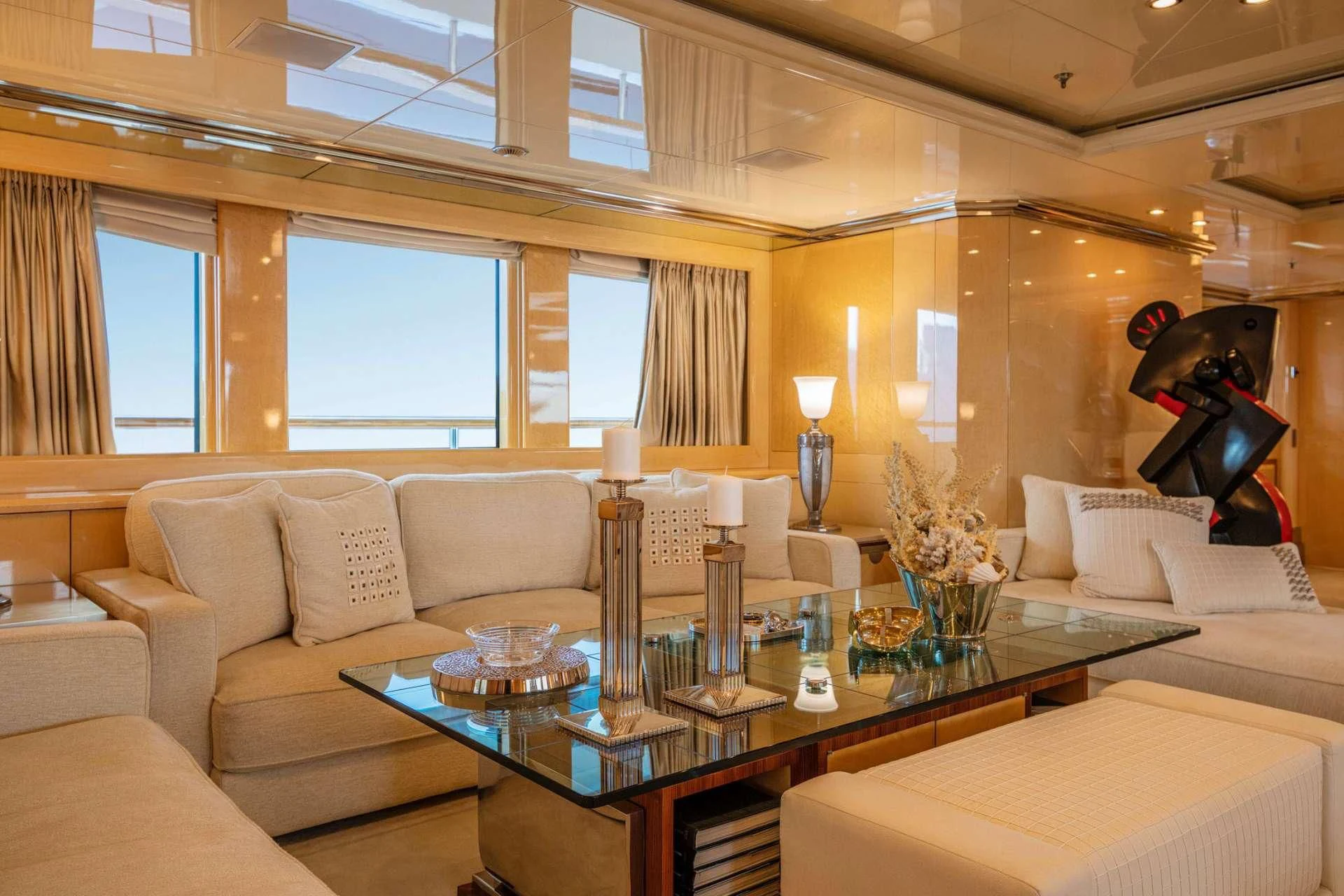 a room with a couch and a table with a stuffed bear aboard SUNDAY Yacht for Charter