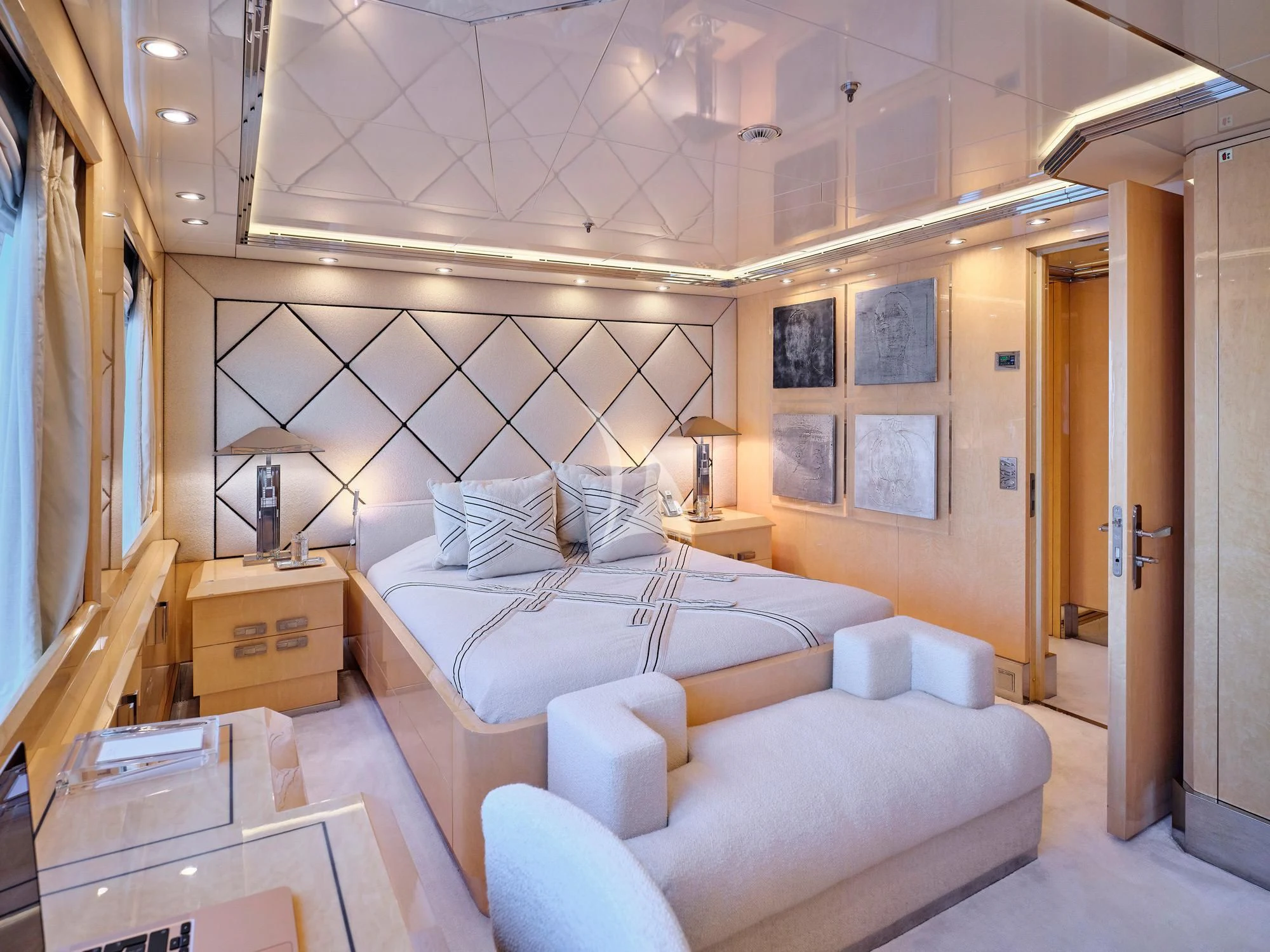 a room with a bed and a desk aboard SUNDAY Yacht for Charter
