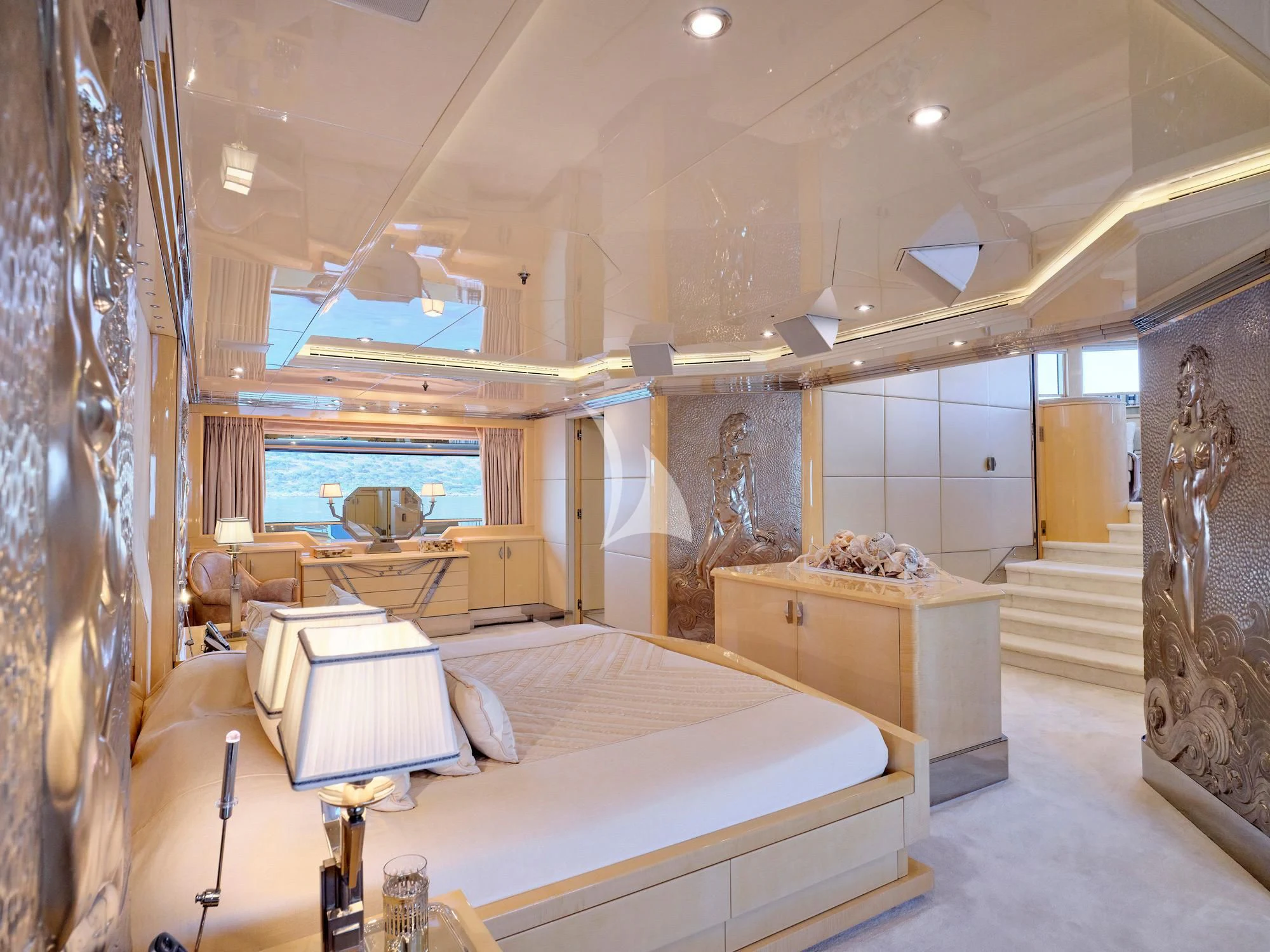 a room with a bed and a table aboard SUNDAY Yacht for Charter