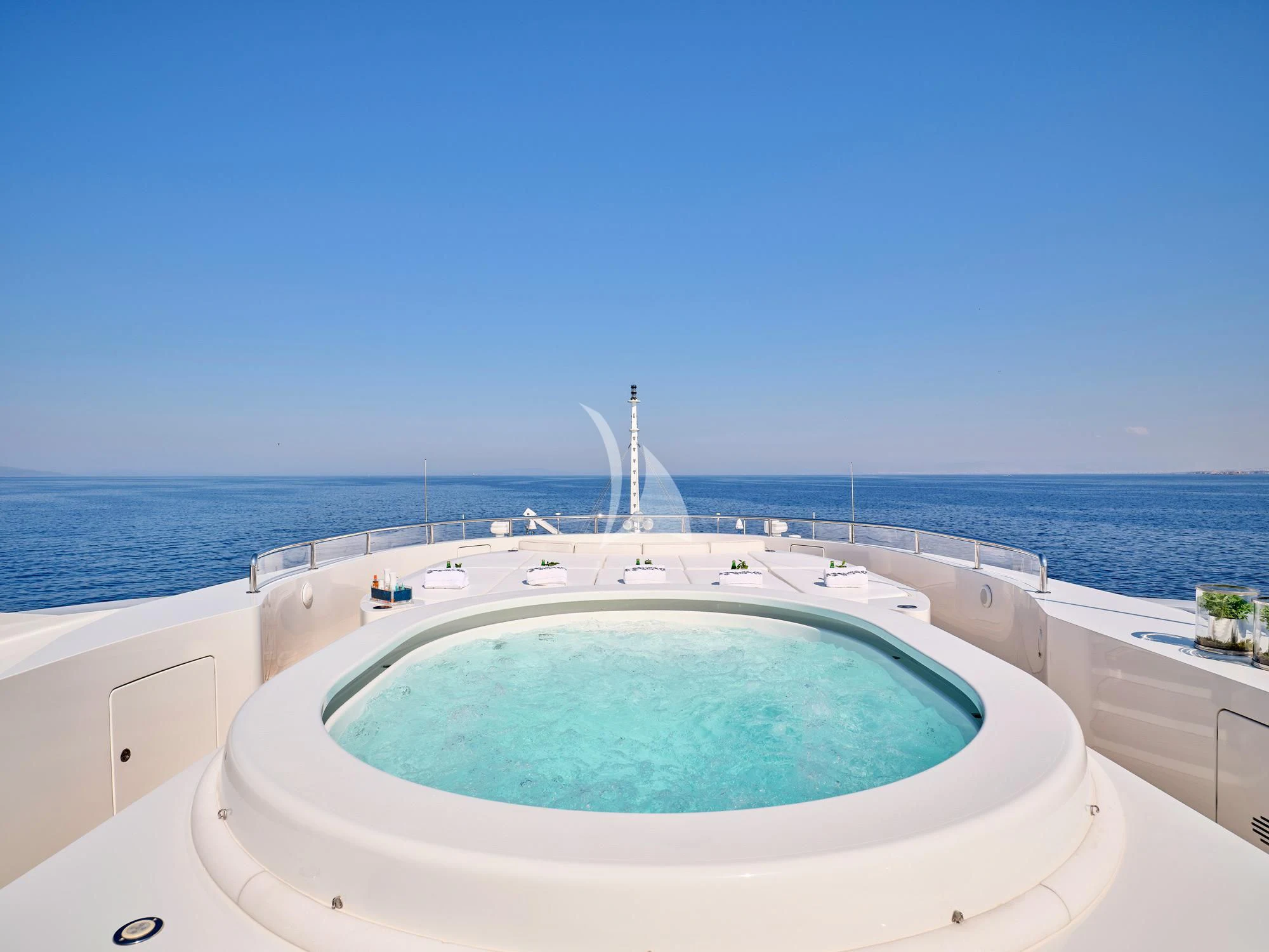 a pool with a view of the ocean and a city in the background aboard SUNDAY Yacht for Charter