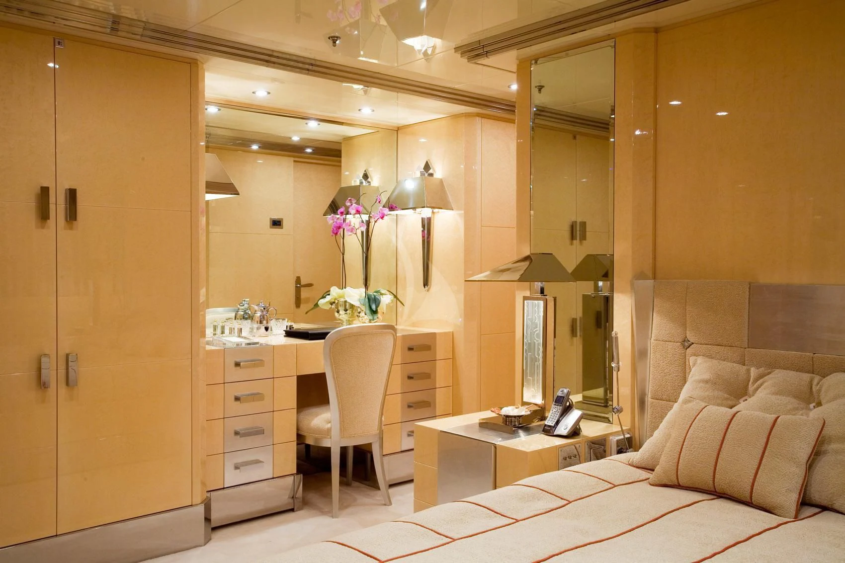 a room with a bed and desk aboard SUNDAY Yacht for Charter