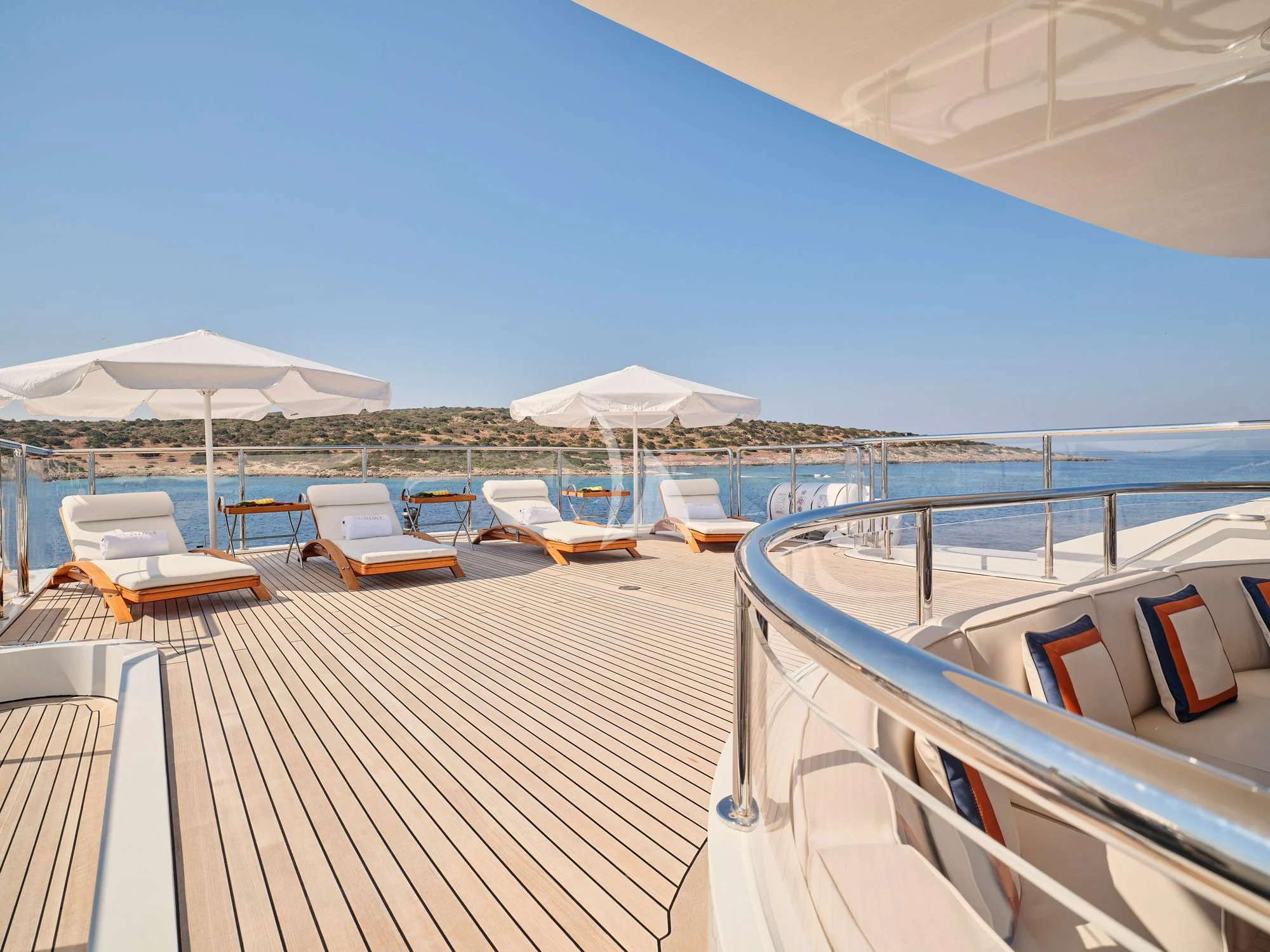 a deck with chairs and umbrellas aboard SUNDAY Yacht for Charter