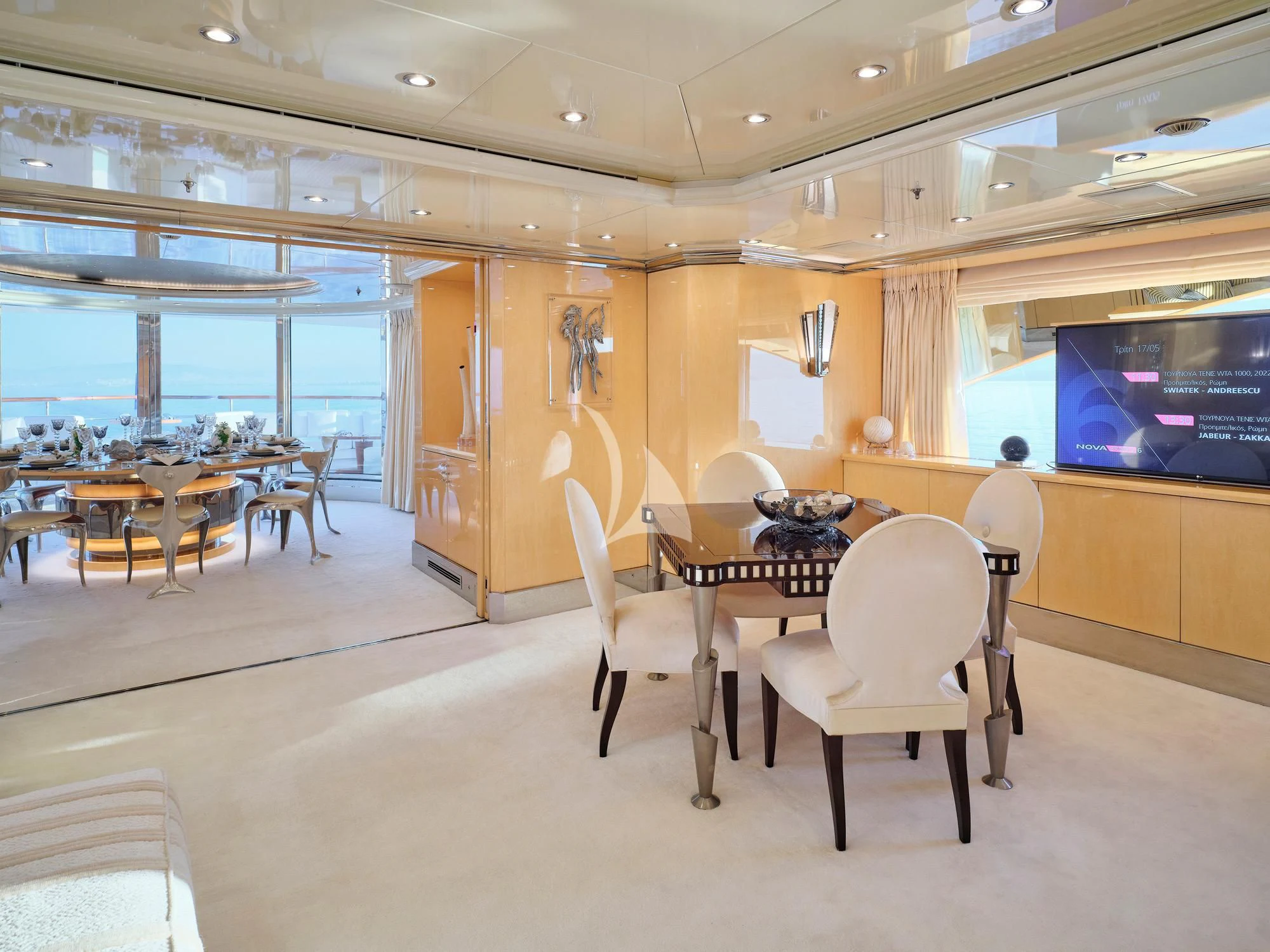 a room with tables and chairs aboard SUNDAY Yacht for Charter