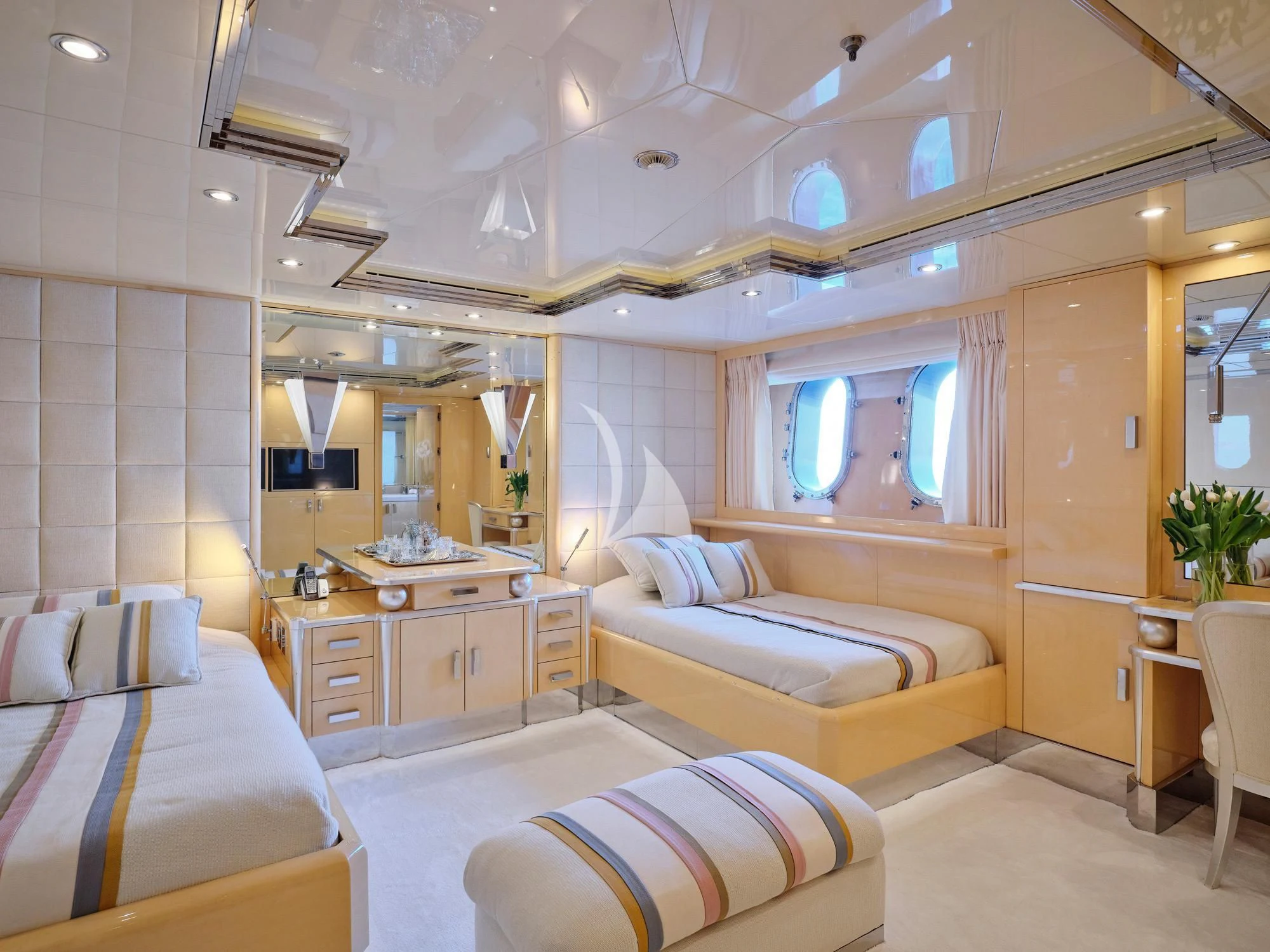 a room with a bed and a mirror aboard SUNDAY Yacht for Charter