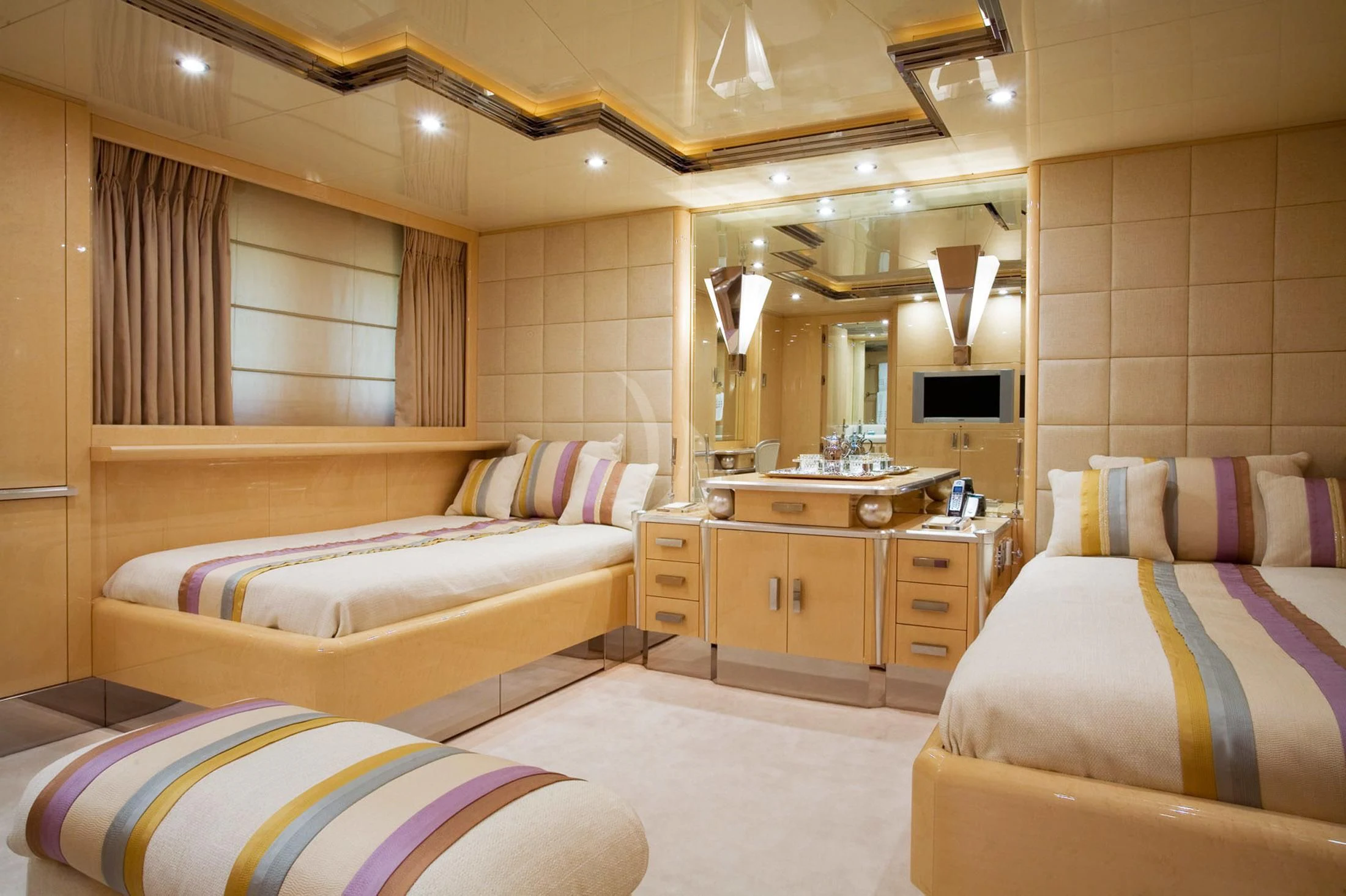 a room with a bed and a mirror aboard SUNDAY Yacht for Charter