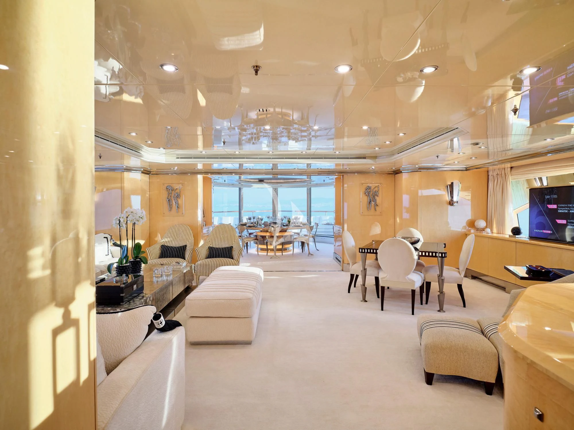 a room with a large chandelier and chairs aboard SUNDAY Yacht for Charter