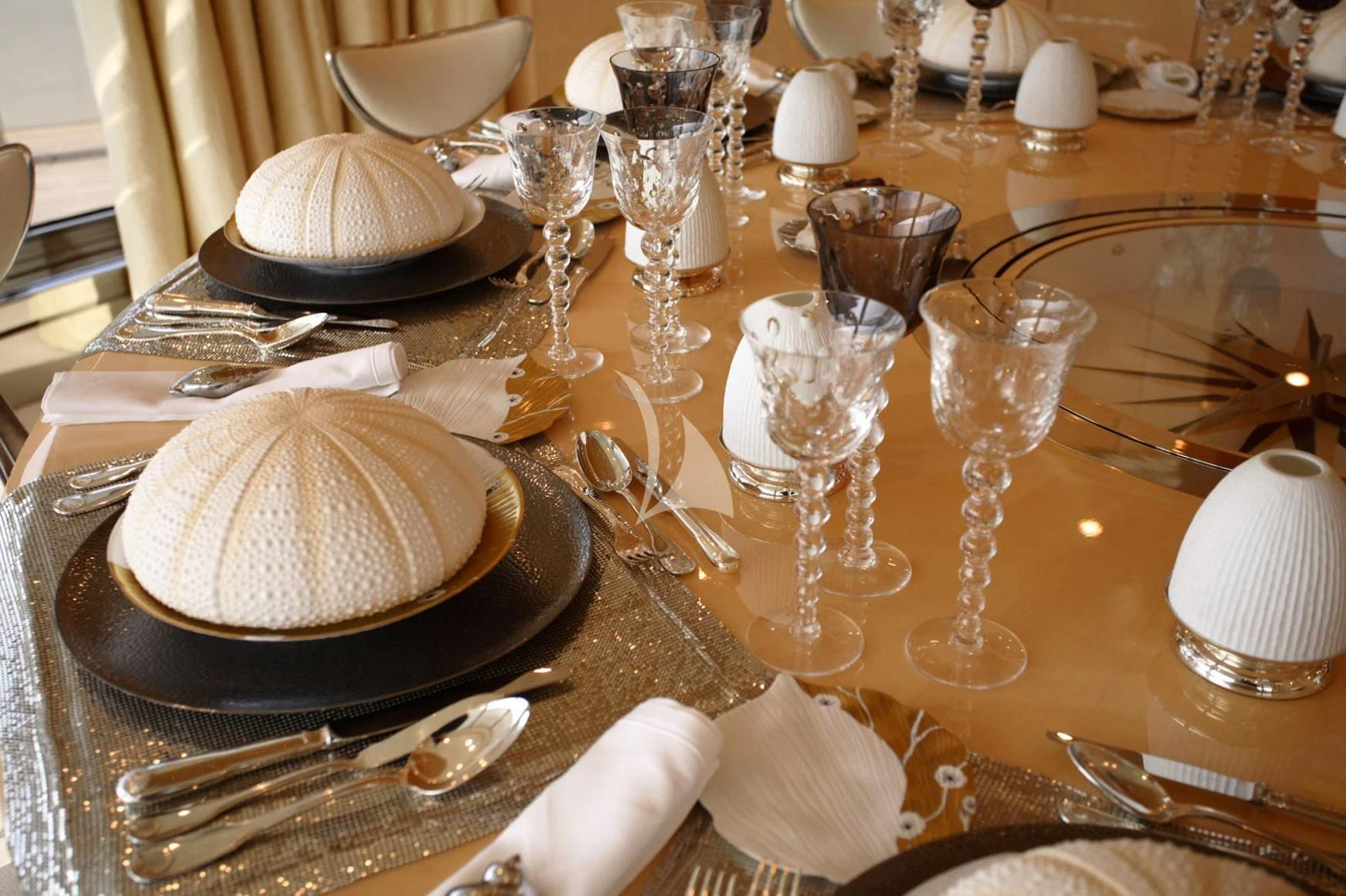 a table with plates and glasses aboard SUNDAY Yacht for Charter