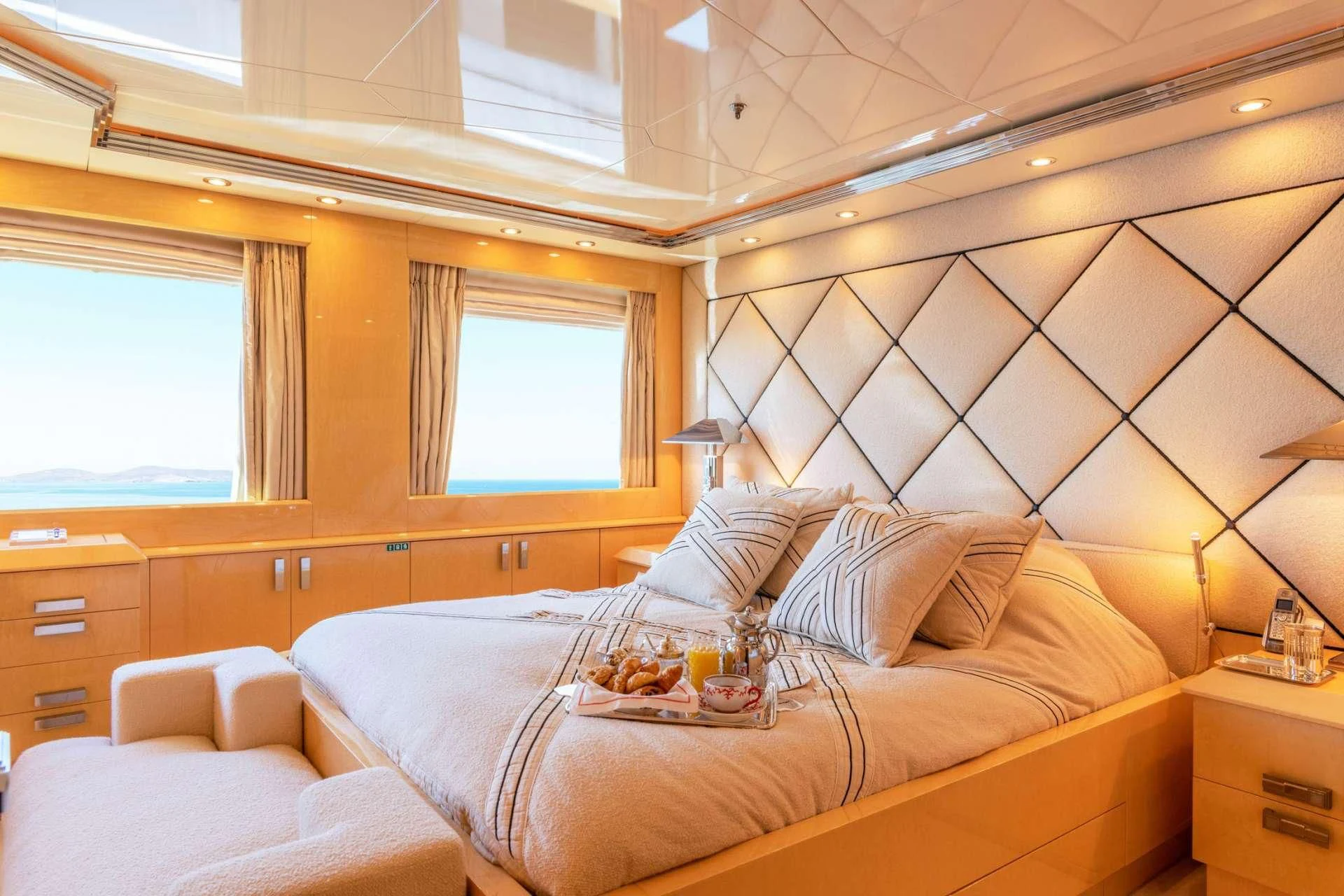a room with a bed and a window aboard SUNDAY Yacht for Charter