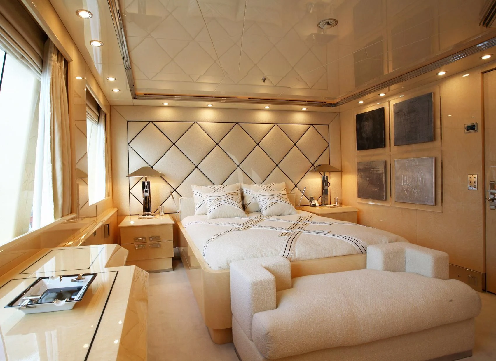 a room with a bed and a desk aboard SUNDAY Yacht for Charter