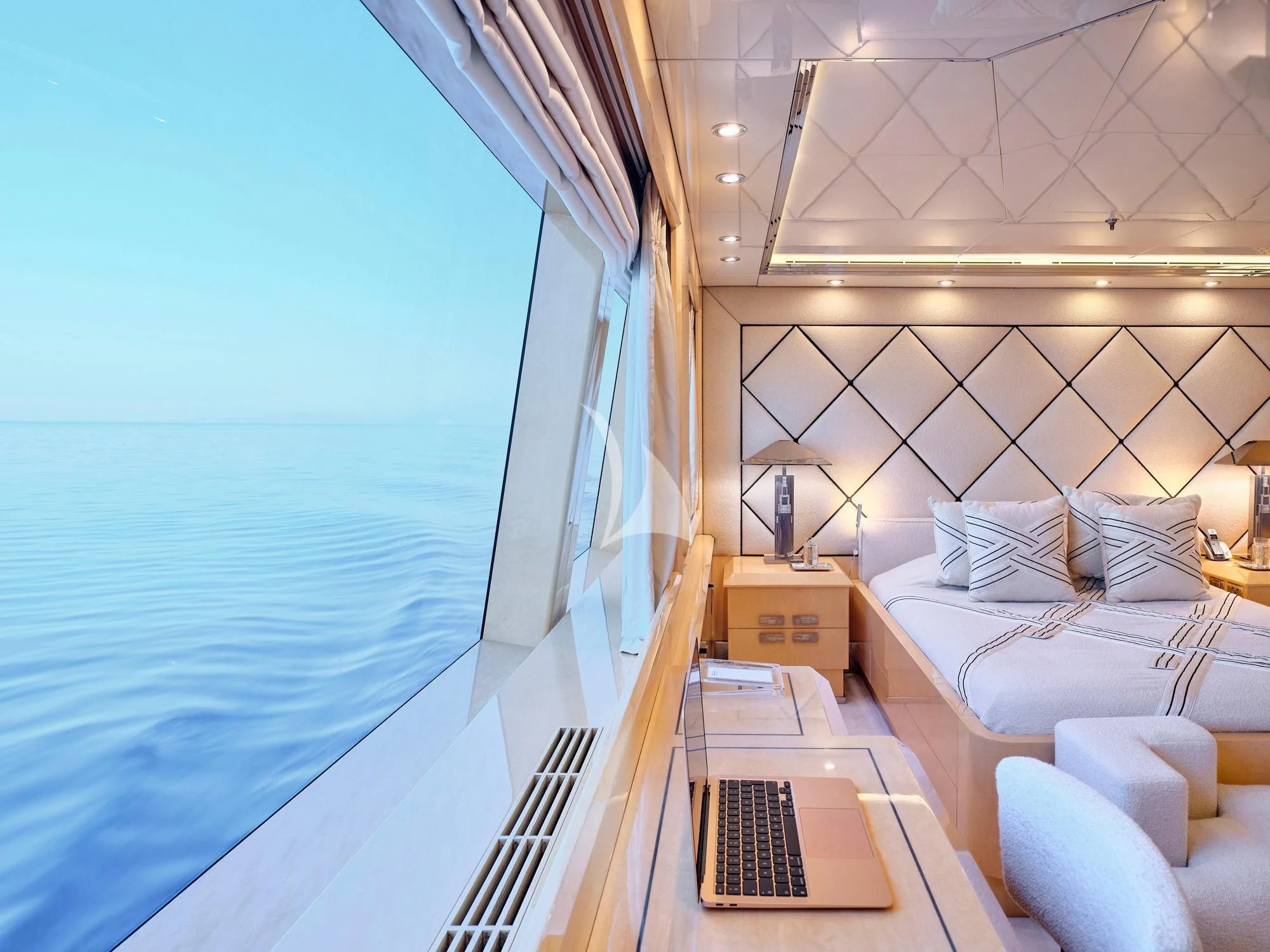 a room with a bed and a desk aboard SUNDAY Yacht for Charter