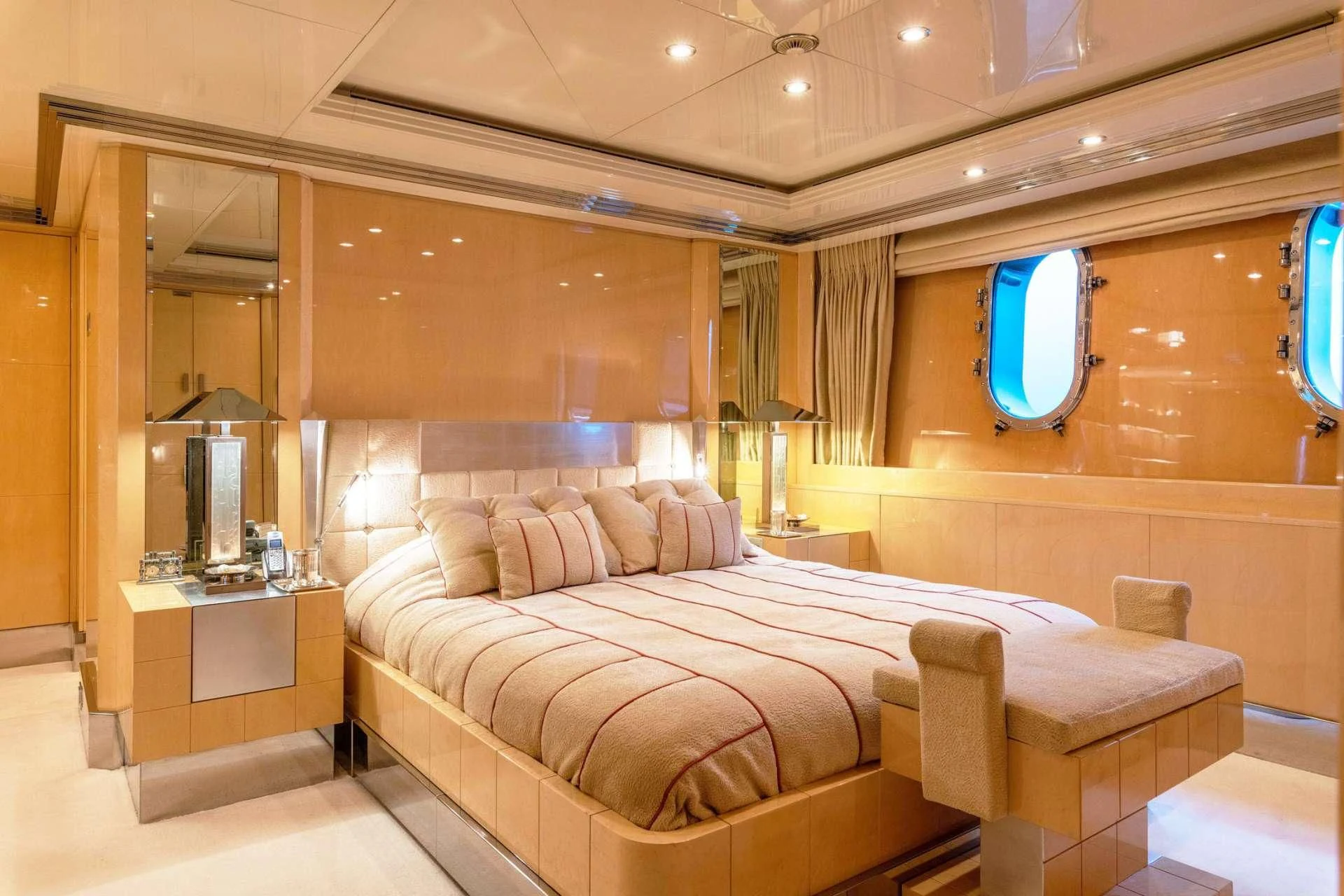 a room with a bed and a mirror aboard SUNDAY Yacht for Charter