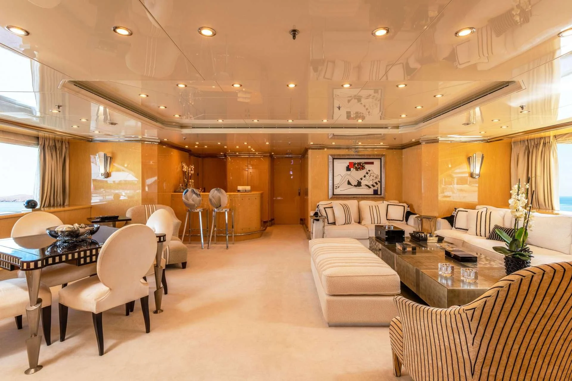 a large living room with a table and chairs aboard SUNDAY Yacht for Charter