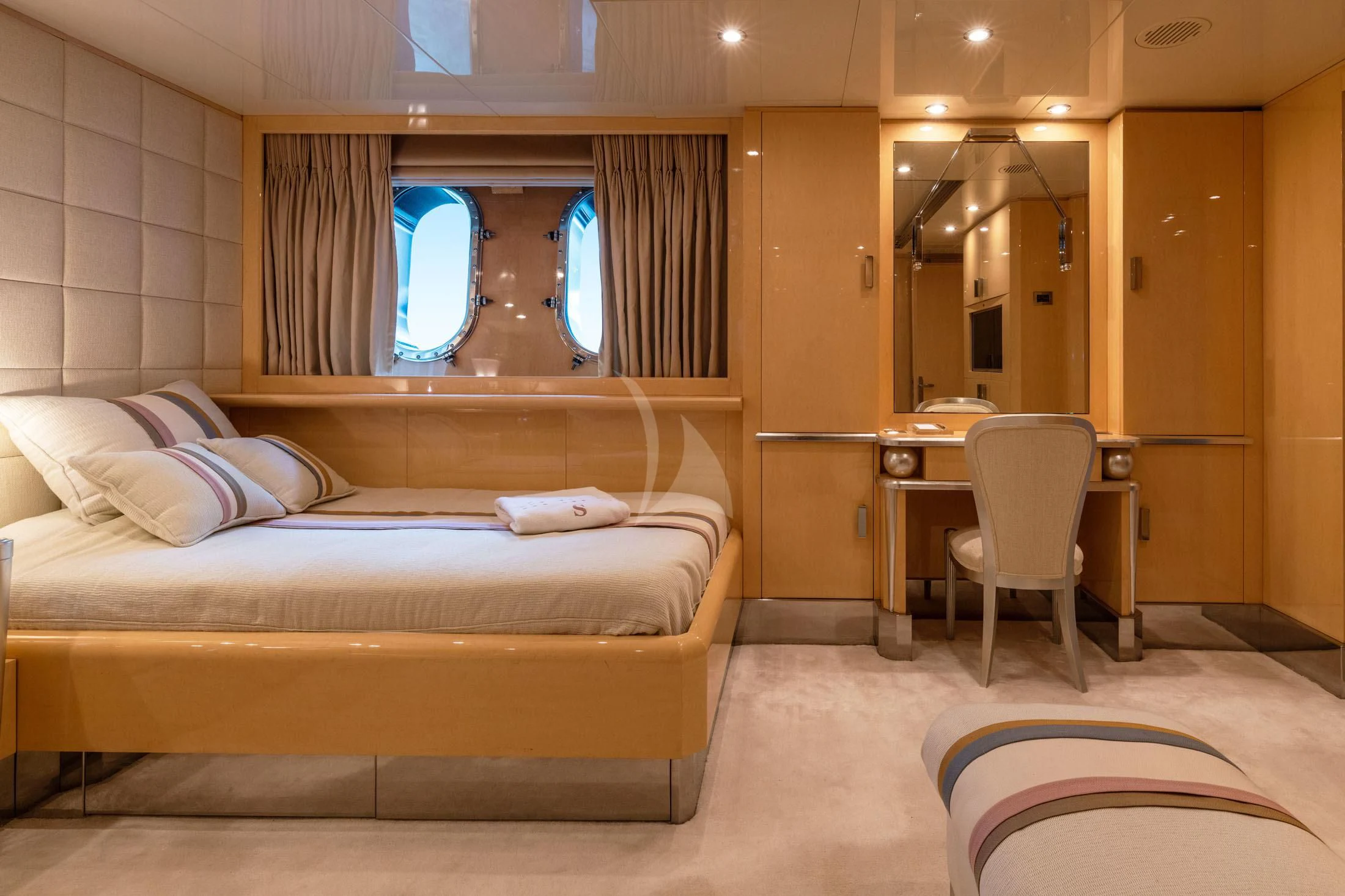 a room with a bed and a desk aboard SUNDAY Yacht for Charter