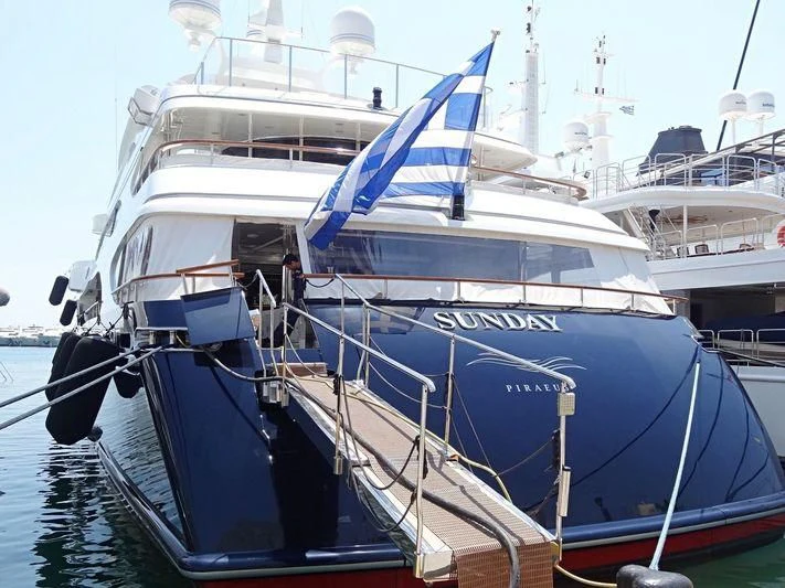 a boat docked at a pier aboard SUNDAY Yacht for Charter