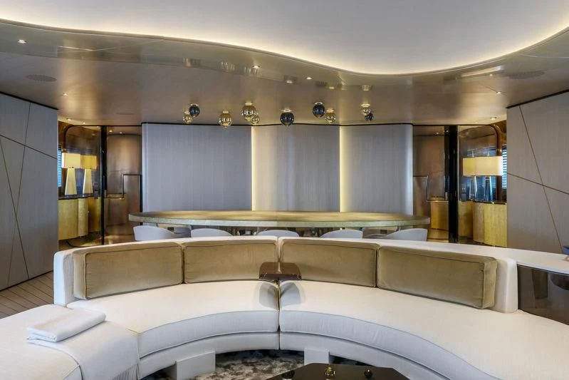 a large room with a couch and a table aboard AURORA Yacht for Sale