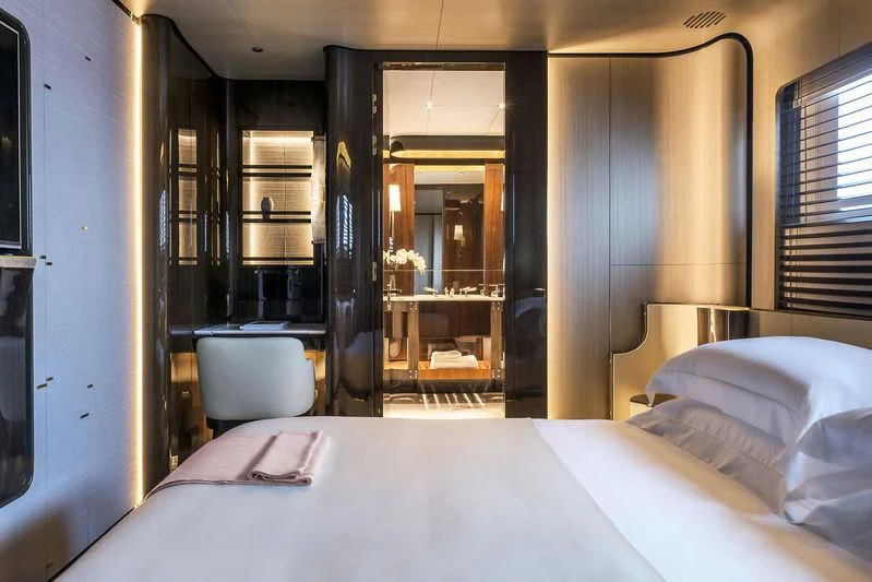 a room with a bed and a chair aboard AURORA Yacht for Sale