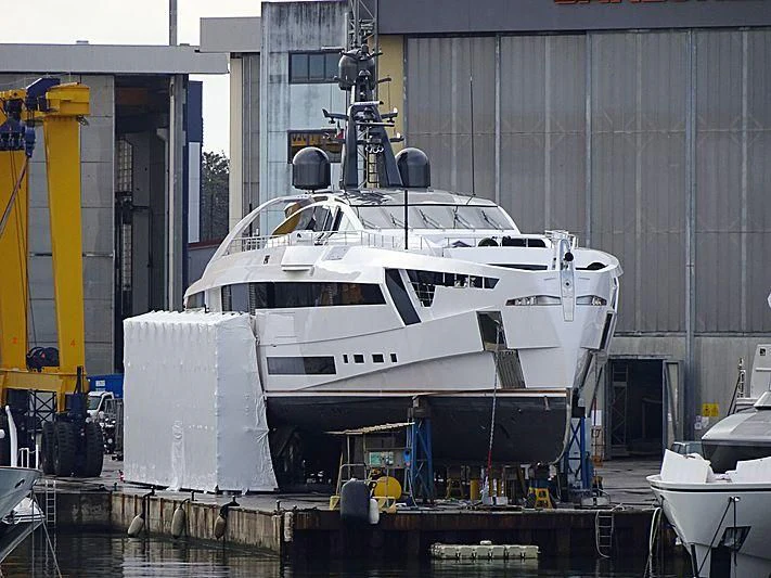 a large white boat sits in a dock aboard AURORA Yacht for Sale