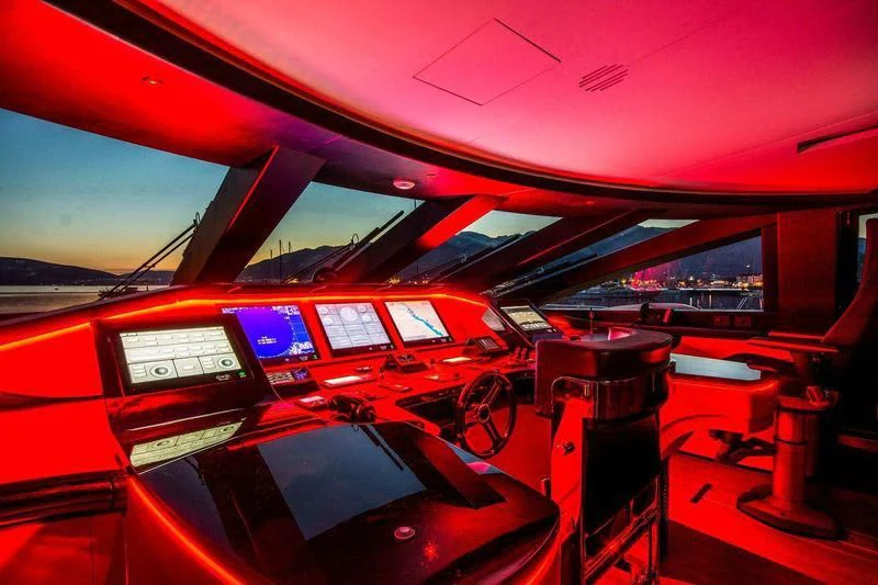 inside of a red car aboard AURORA Yacht for Sale