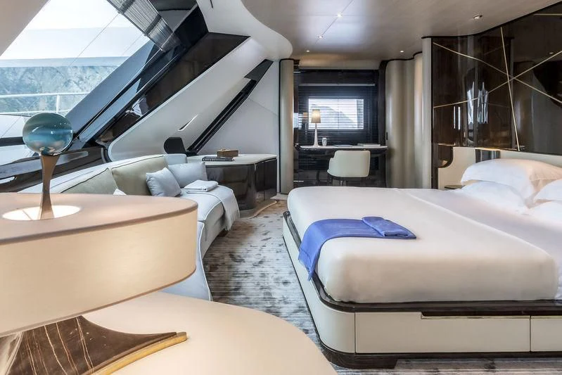 a room with beds and a table aboard AURORA Yacht for Sale